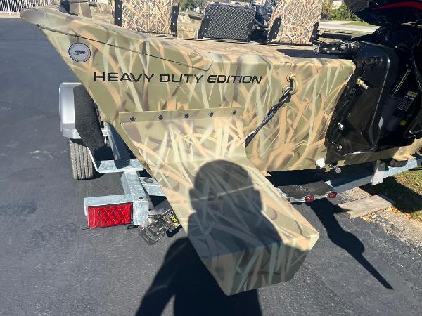 2025 Lowe Roughneck 2070 SC boat, camo design, "Heavy Duty Edition" text, on a trailer.