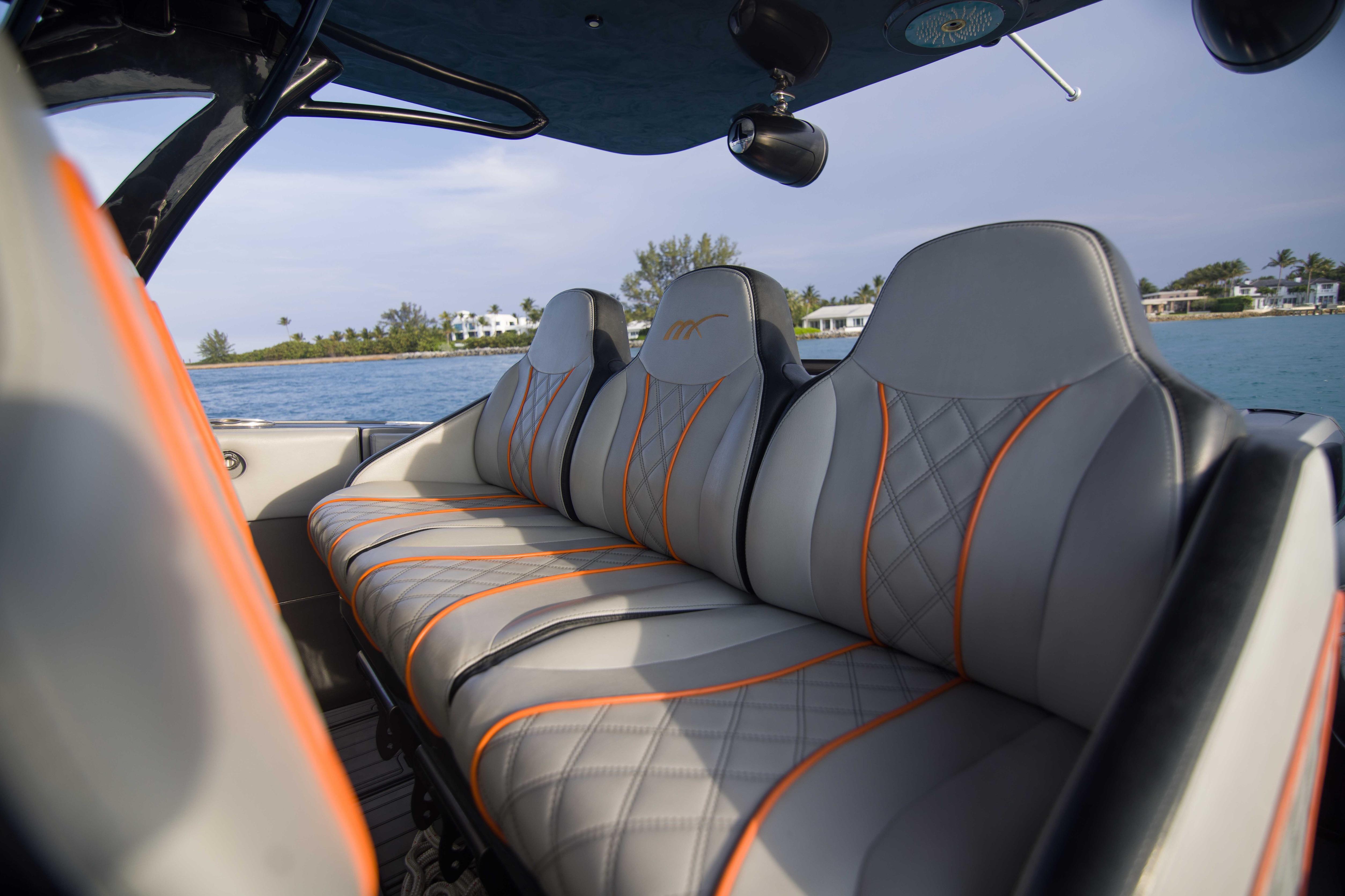 Luxurious seating on 2019 Midnight Express 43 Open boat with scenic water view.