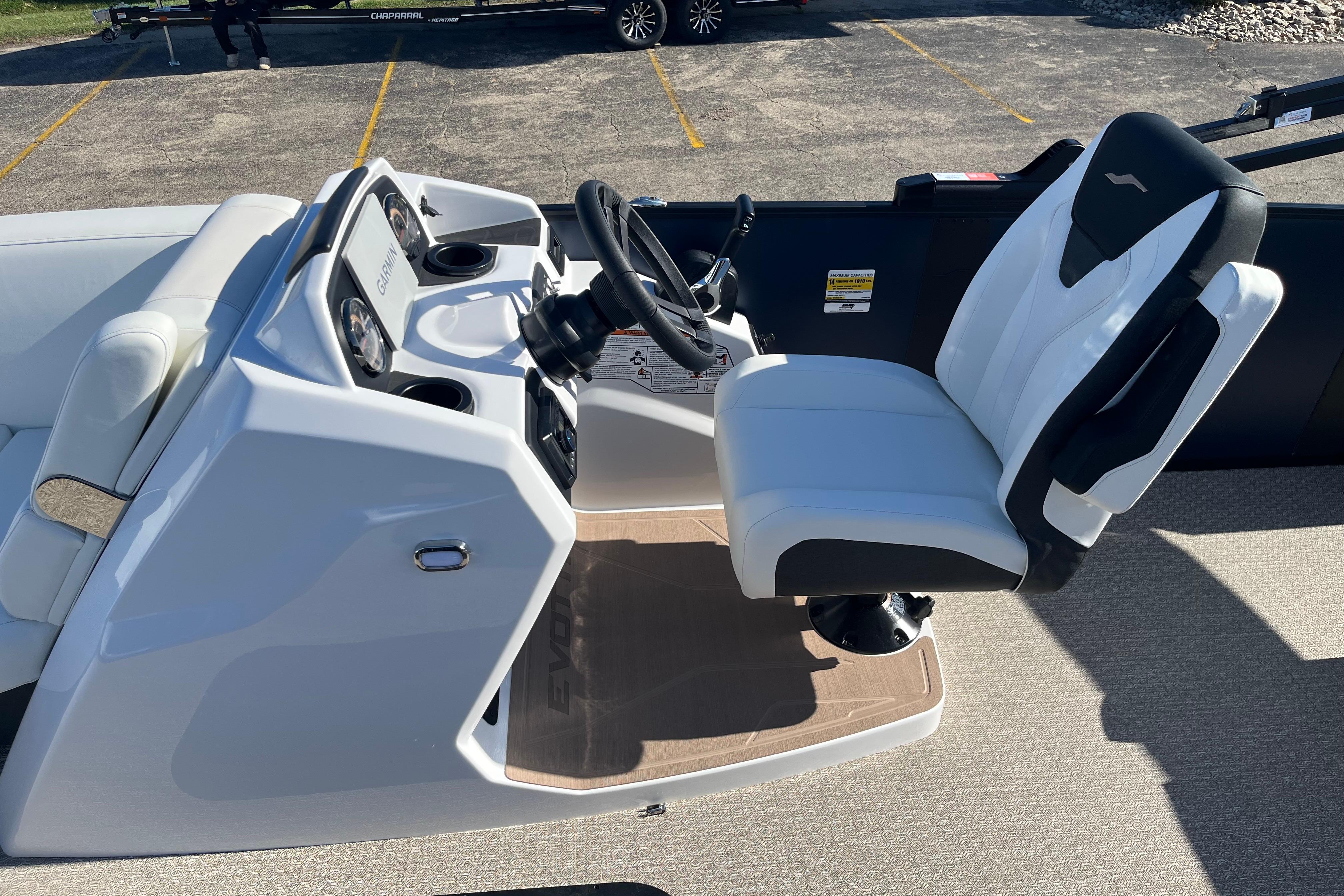Captain's seat and control panel of 2026 Evotti 523CS boat, featuring modern design and technology.