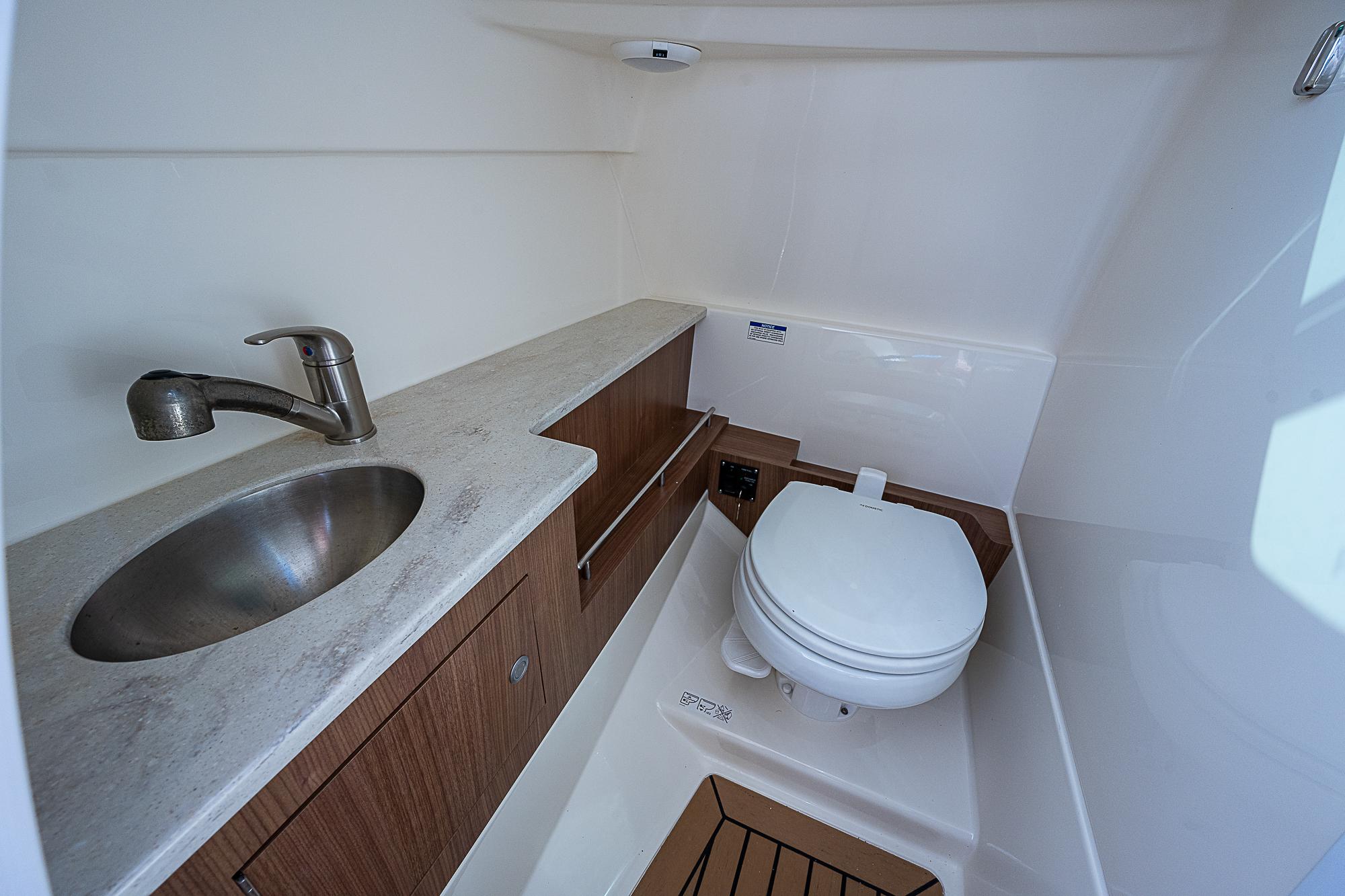 2018 Boston Whaler 270 Vantage boat bathroom with sink and toilet.