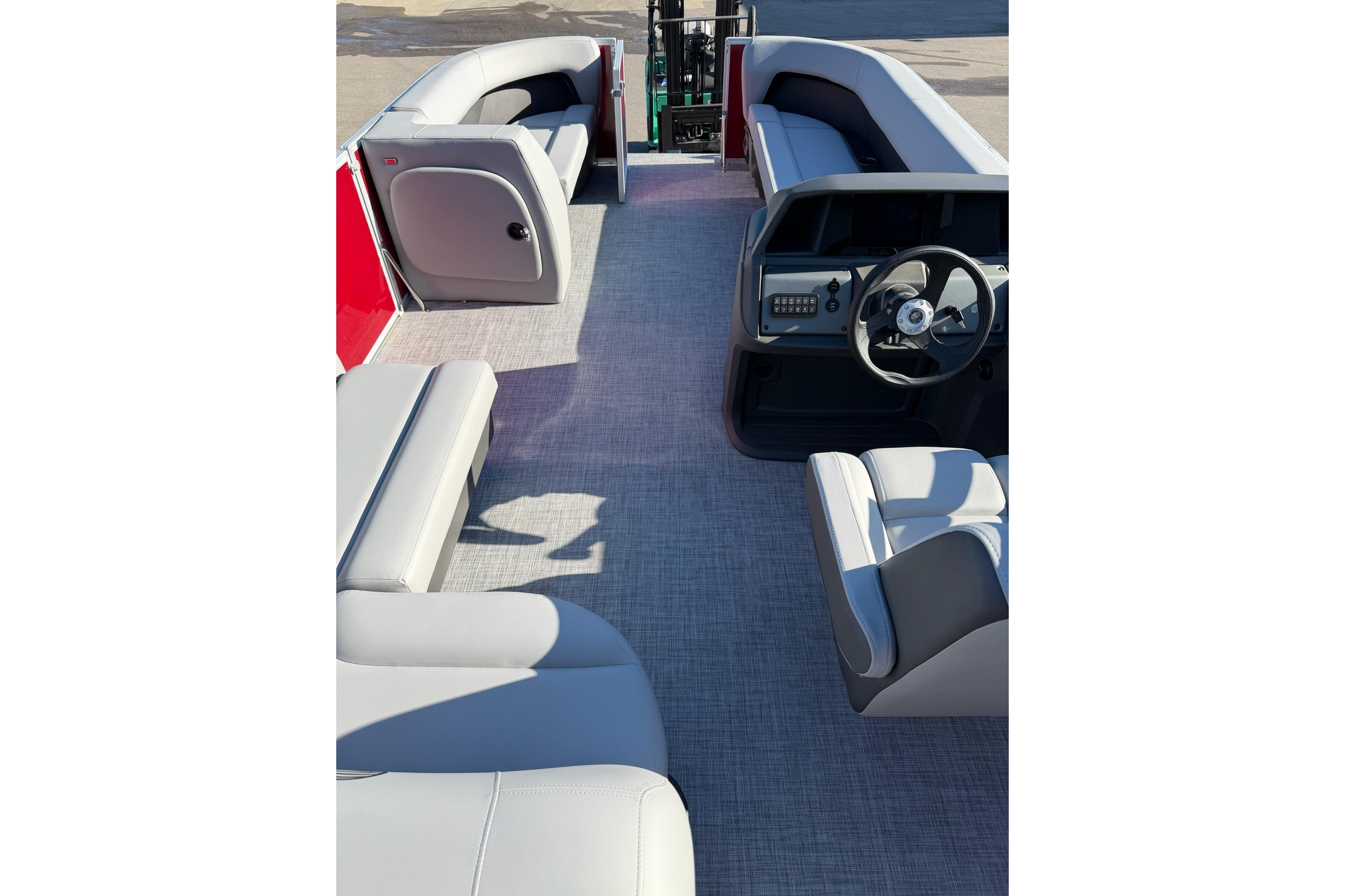 2026 Sun Tracker Party Barge 18 DLX interior with spacious seating and modern helm.