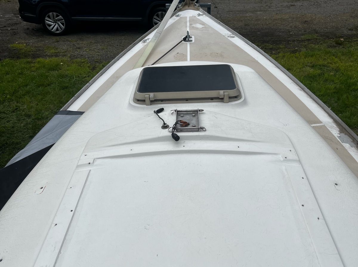 Deck of a 1981 Cape Dory 22-1 sailboat, featuring hatches and rigging.