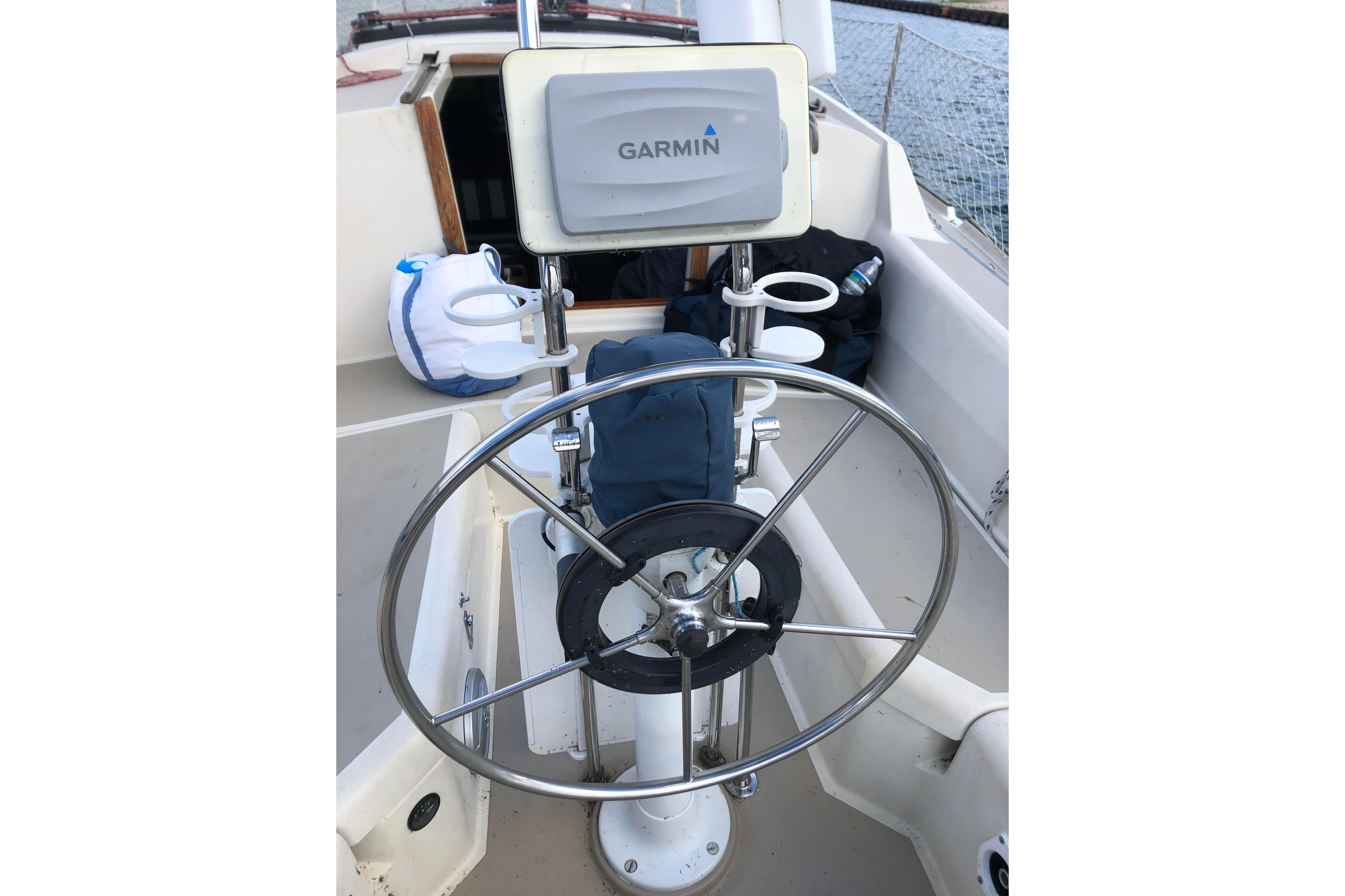 Cockpit of 1983 O'Day 34 sailboat with Garmin navigation system and steering wheel.