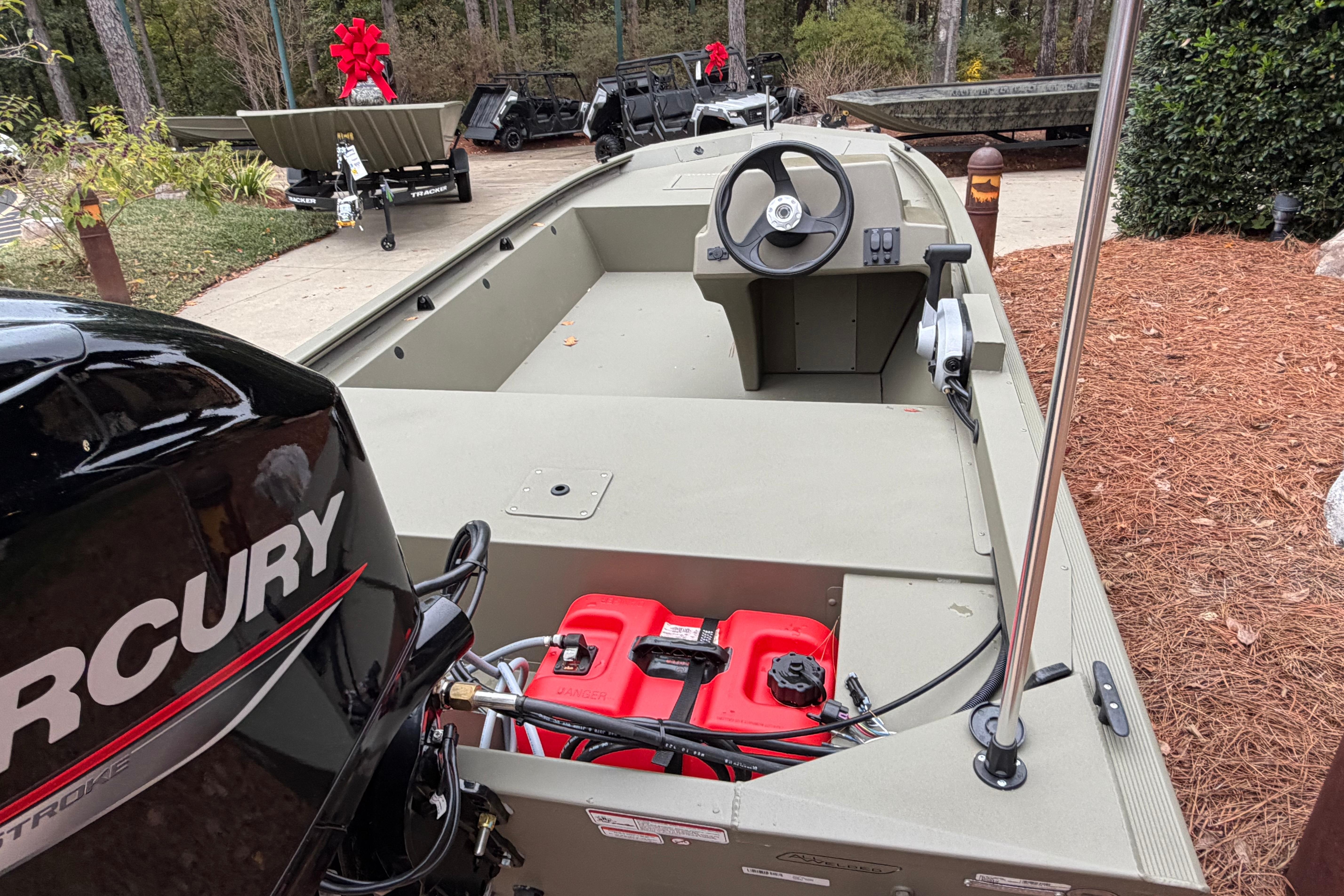 2026 Tracker Grizzly 1648 SC boat with Mercury engine, displayed outdoors.
