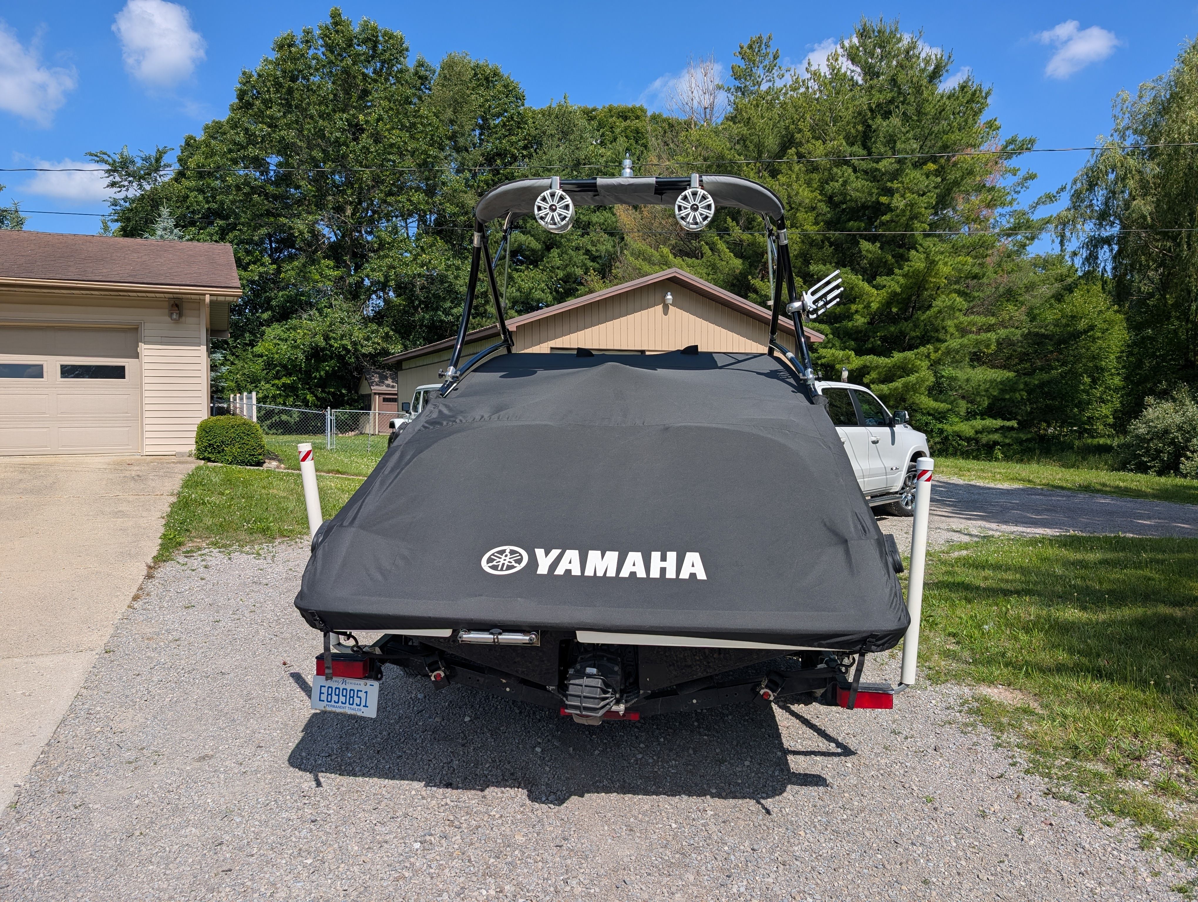 A 2014 Yamaha AR192 boat on a trailer in a yard.