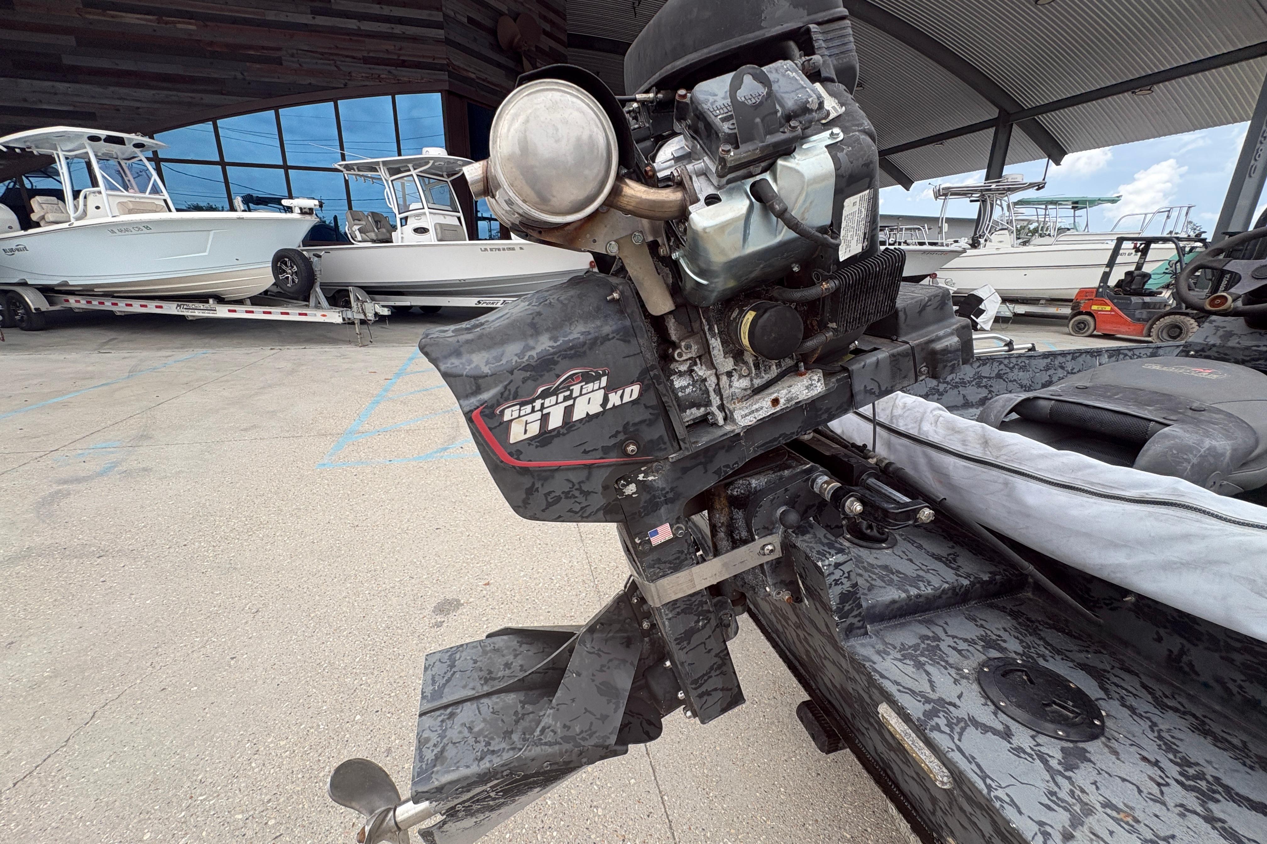 2020 Gator Tail Extreme boat motor in a marina setting with other boats.