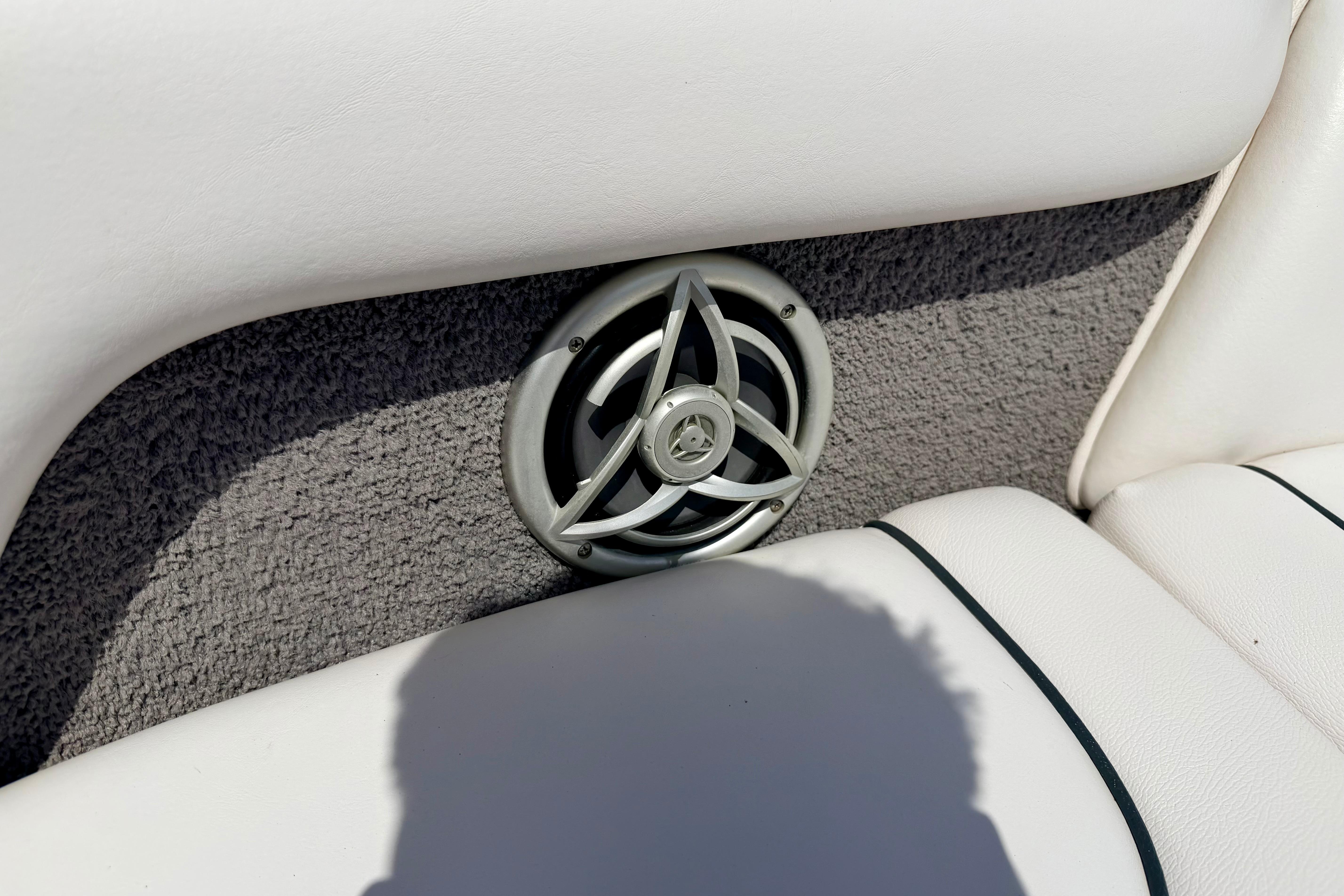 Speaker on 2008 Moomba Outback V boat with white upholstery and gray carpet.