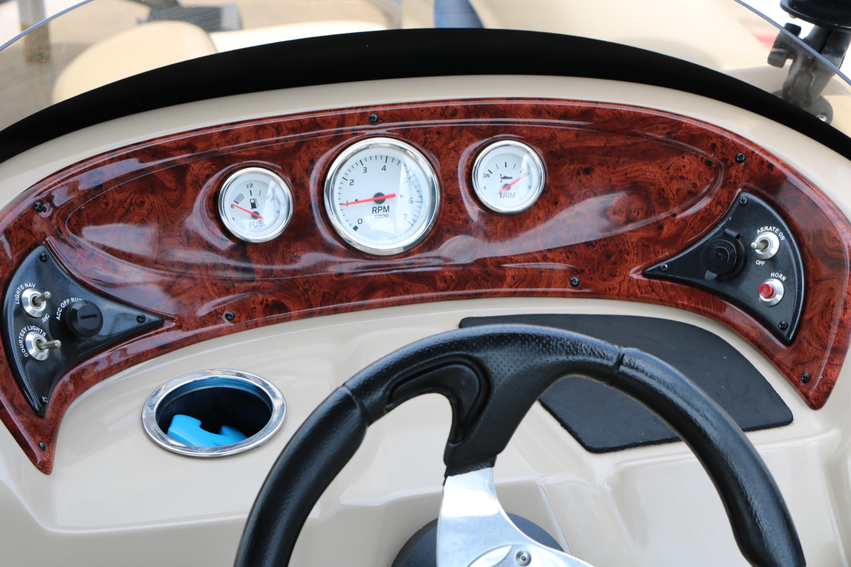 Dashboard of 2013 Sun Tracker Fishin' Barge 20 DLX with gauges and controls.