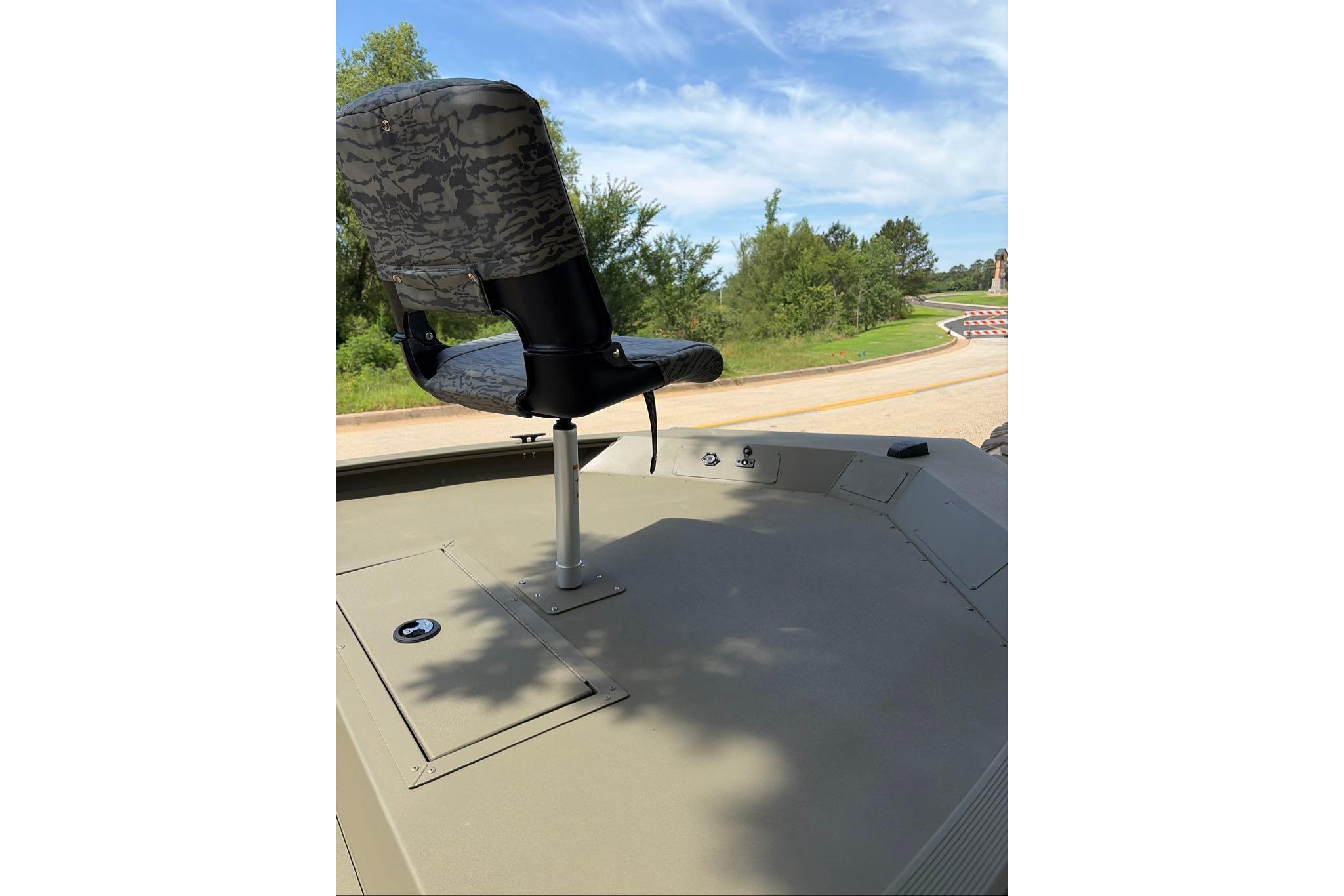 2026 Tracker Grizzly 1654 T Sportsman boat with camo seat, outdoors.