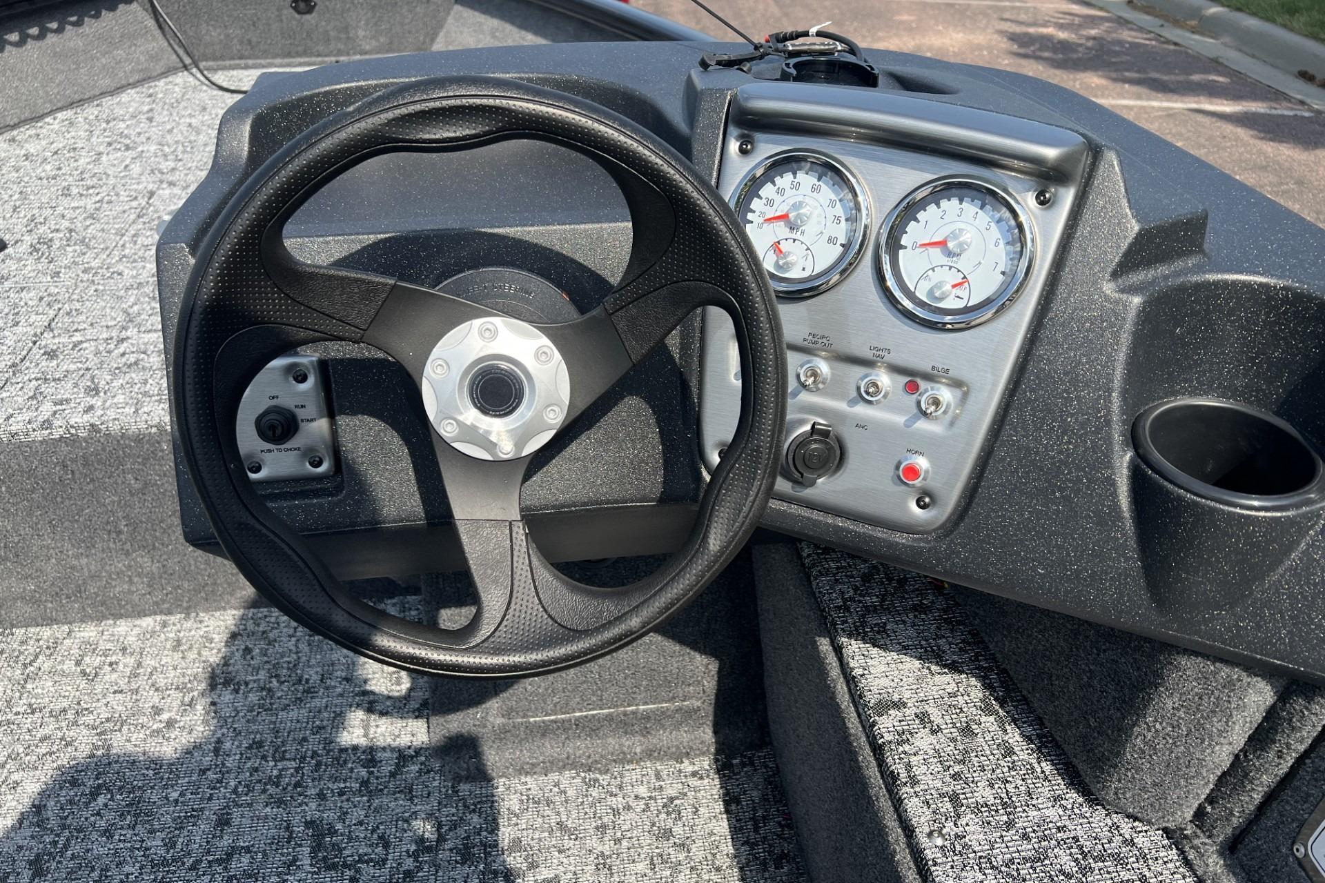 Steering wheel and dashboard of 2026 Tracker Pro Guide V-16 SC boat.