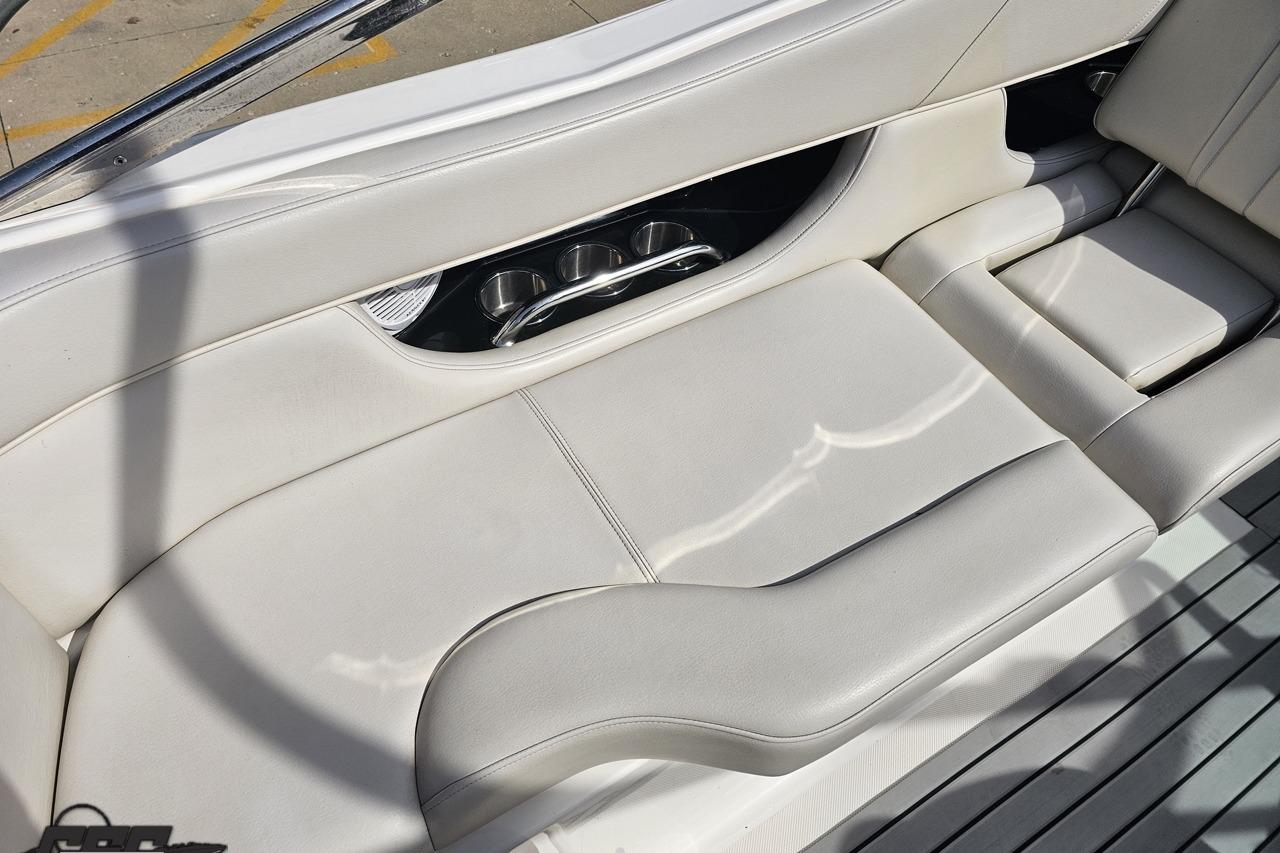 Luxurious seating on a 2008 Regal 2520 FasDeck boat with integrated cup holders.