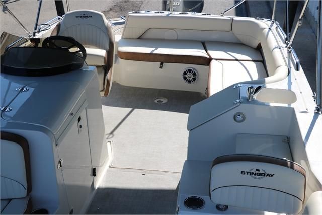 Interior view of a 2022 Stingray 212 SC with beige seating and steering wheel.