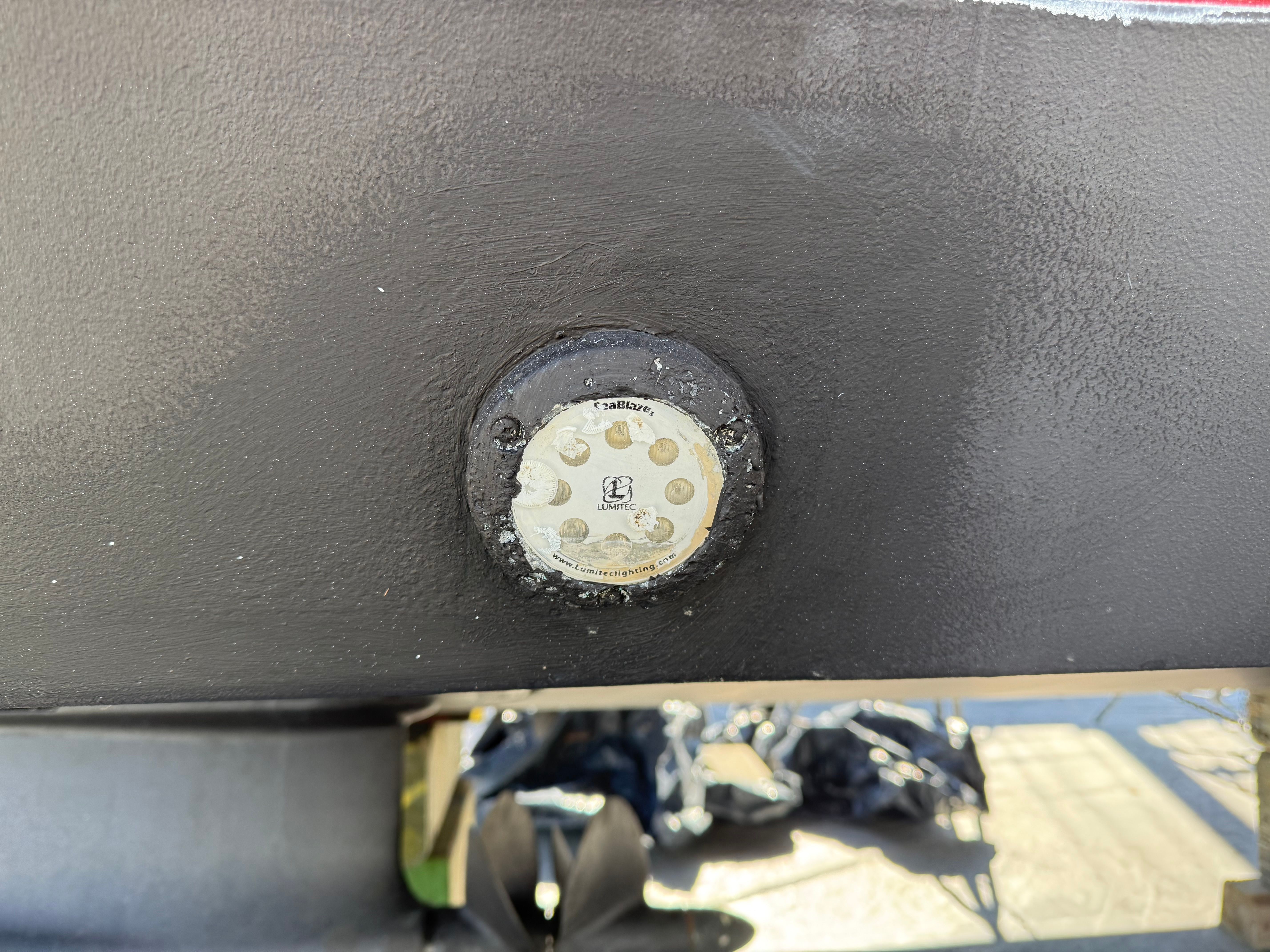 Close-up of a boat part featuring a round, metallic element.