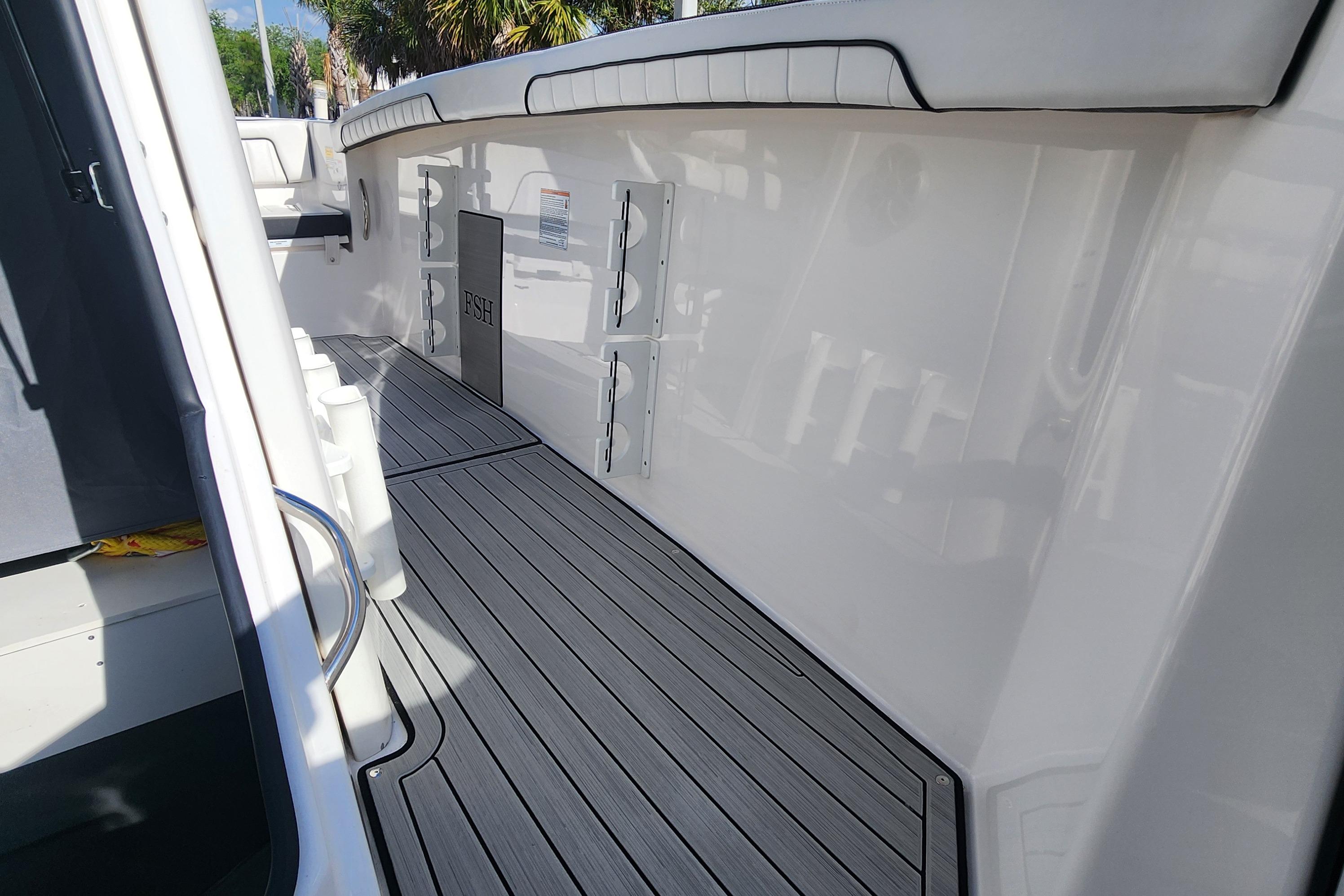 2022 Yamaha 255 FSH Sport E boat interior with sleek deck and storage compartments.