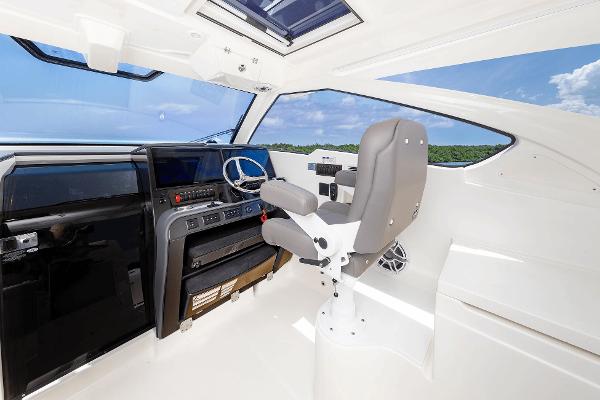 Helm of 2025 Pursuit OS 405 boat with modern controls and panoramic view.