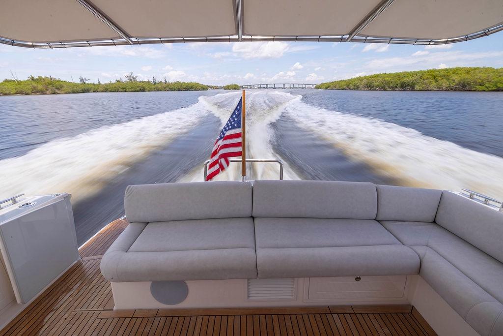 2024 Grand Banks 44 Eastbay cruising, featuring a spacious deck and American flag.