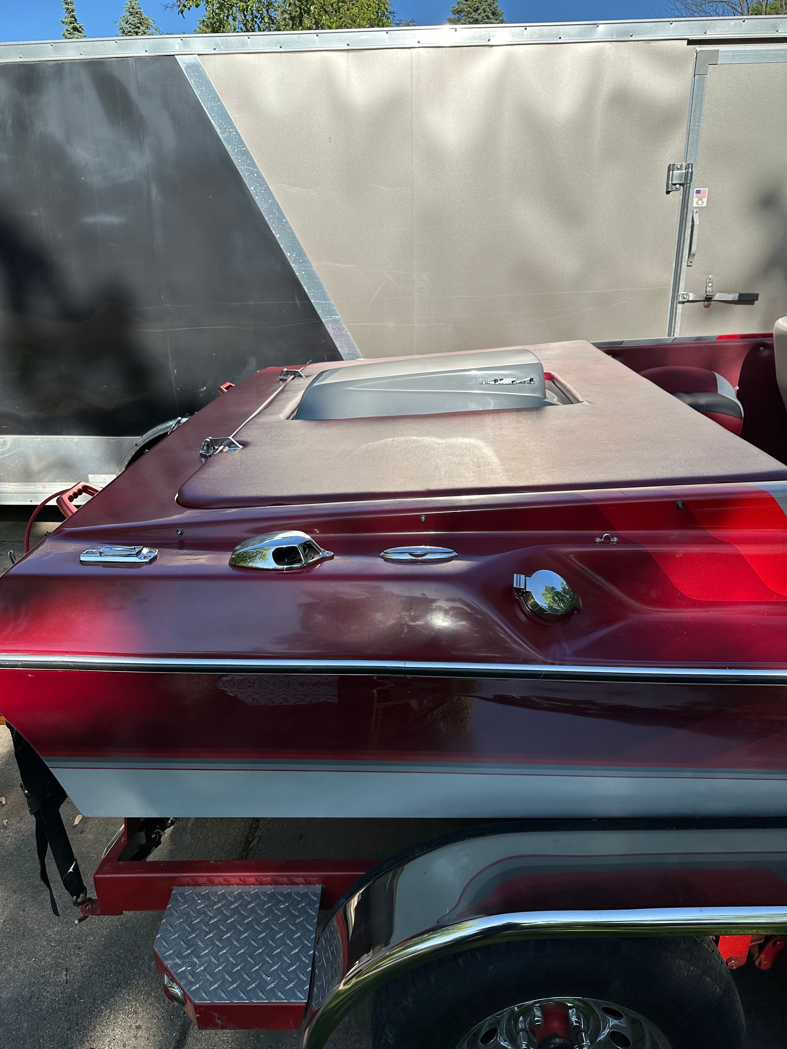 Red 1989 Custom Jet Boat 22' parked on trailer.