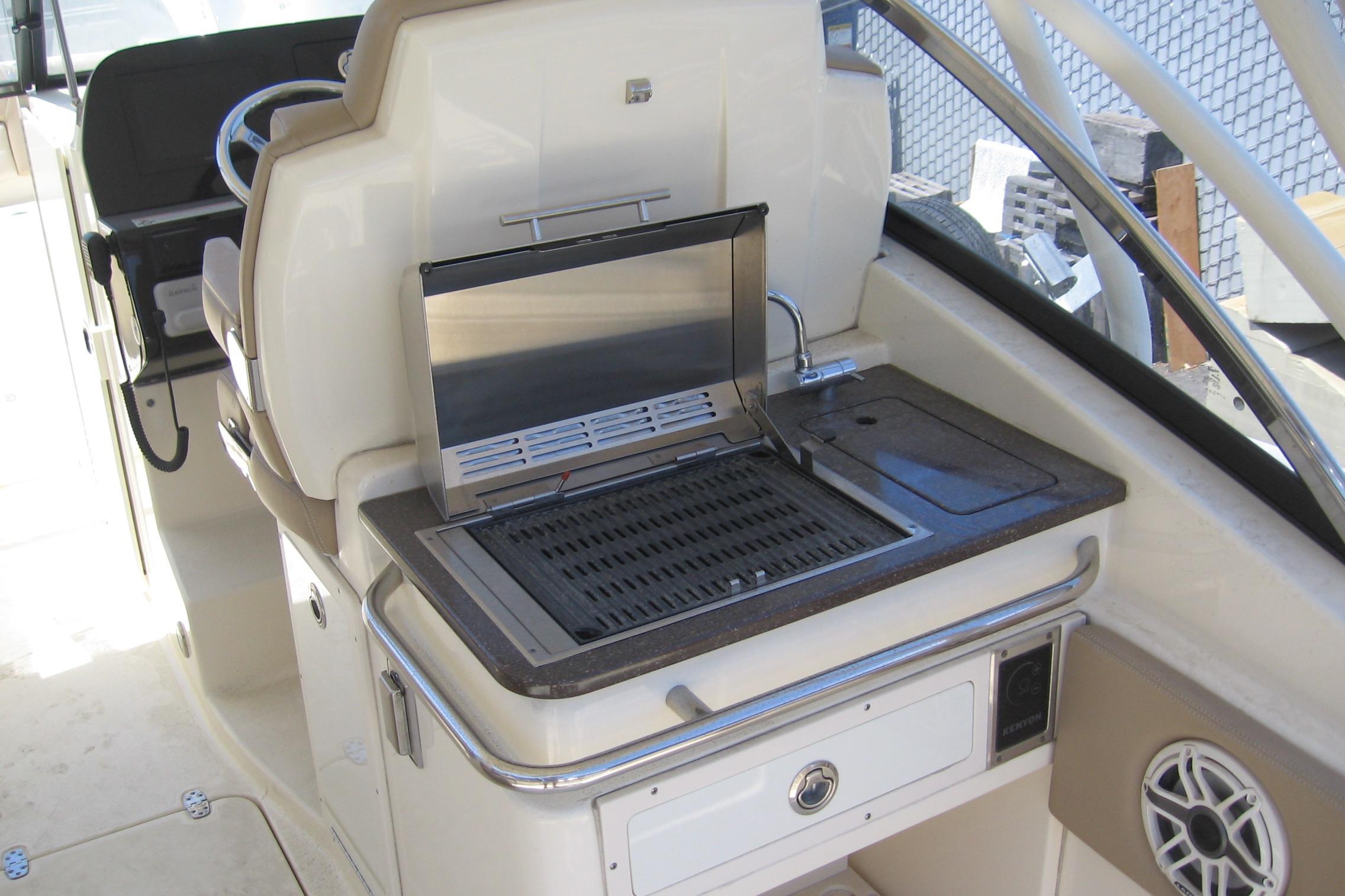 2024 Scout 255 Dorado boat interior with built-in grill and sink.