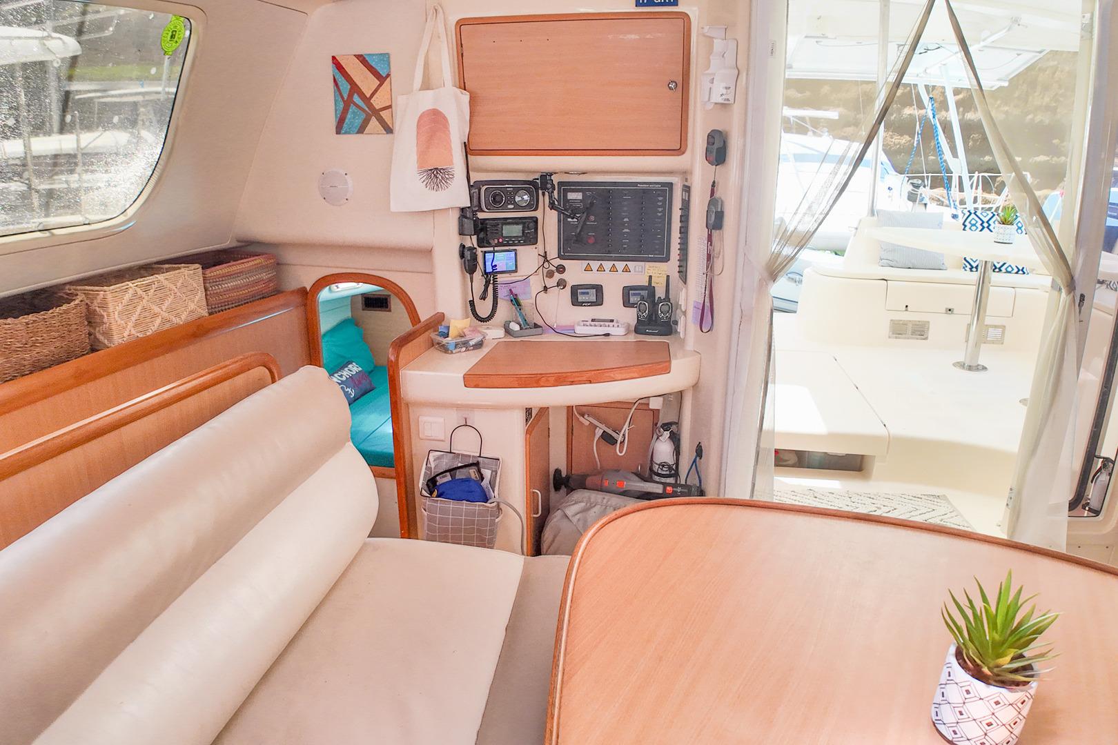Interior of a 2005 Leopard 43 catamaran with navigation equipment and cozy seating area.