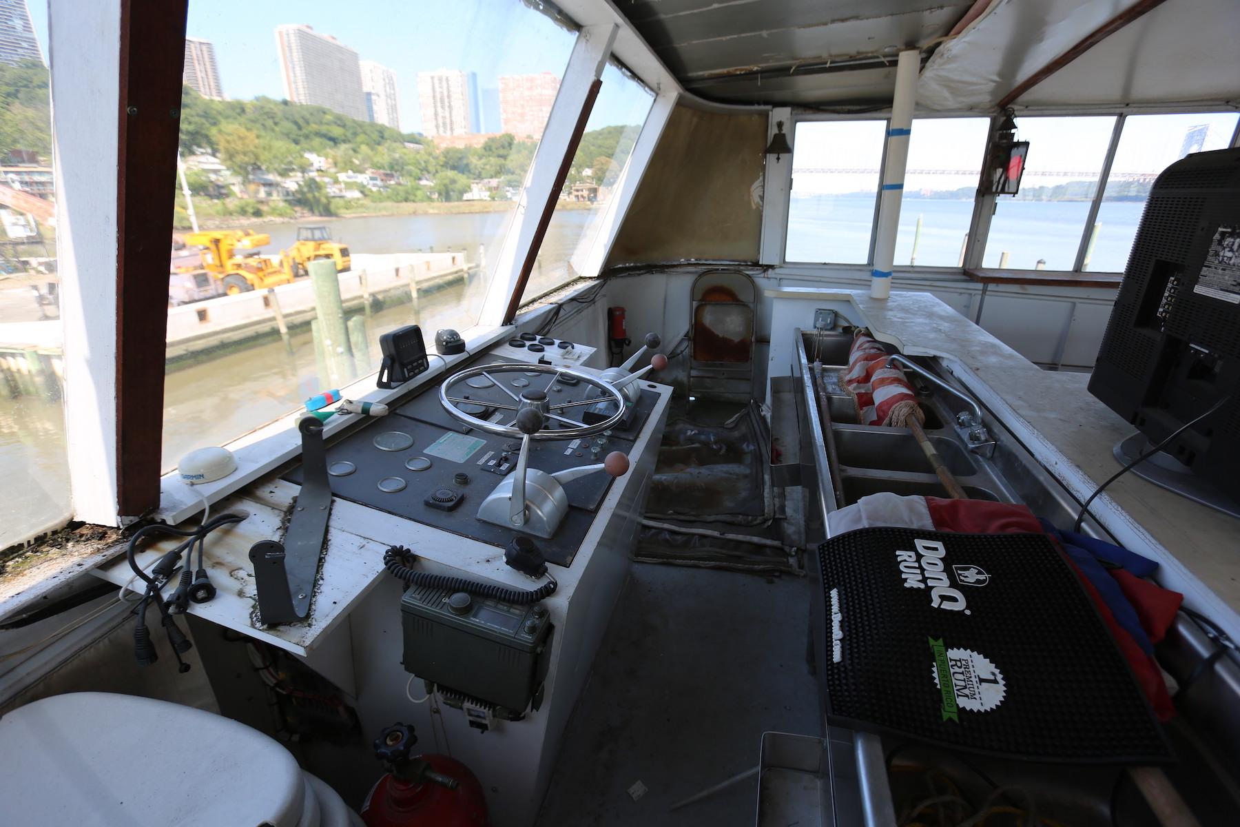 Cockpit of 1988 Winston Knauss 64 Party Boat with steering wheel and control panel.