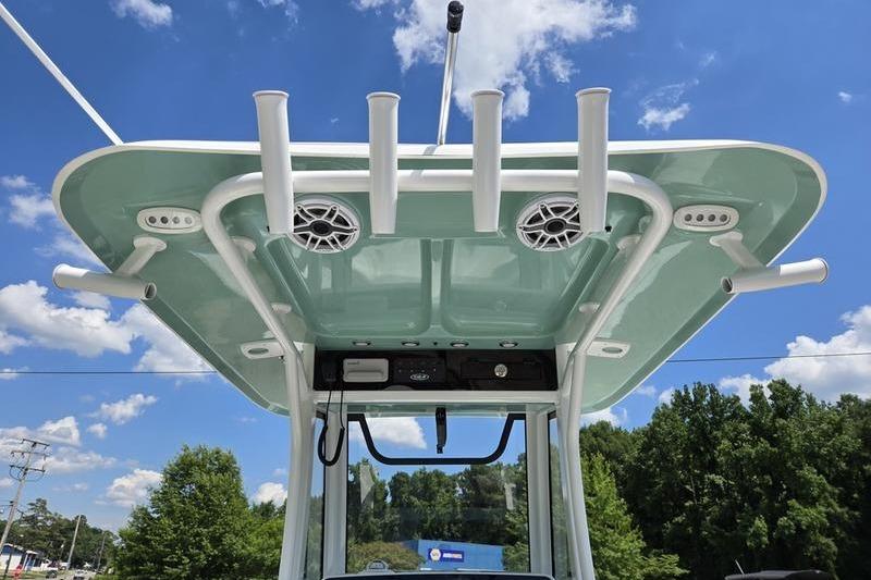 2027 Sea Hunt Ultra 275 SE boat top with rod holders and speakers under blue sky.
