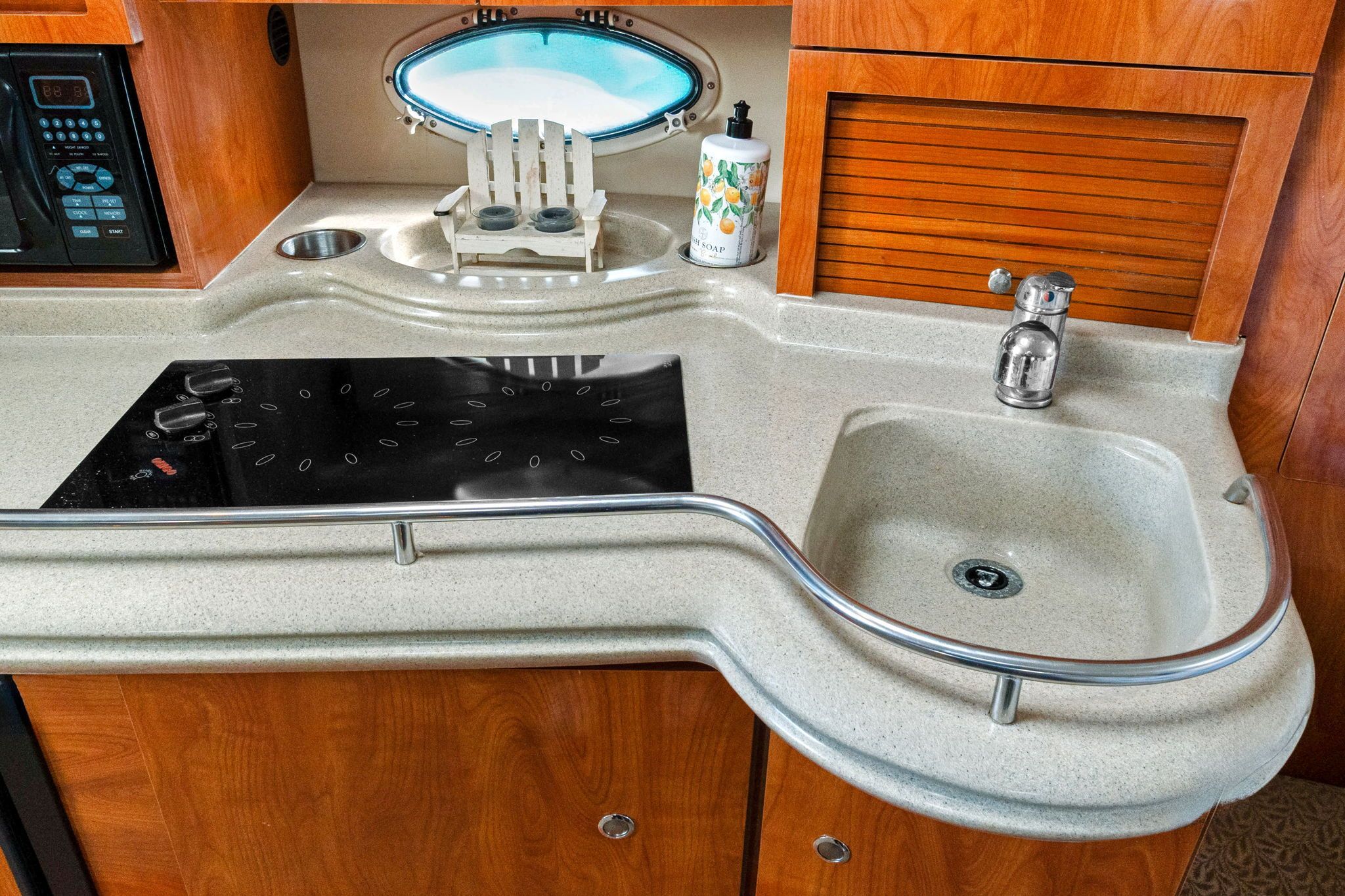 The 2007 Larson Cabrio 330's galley features a sink and a stove.