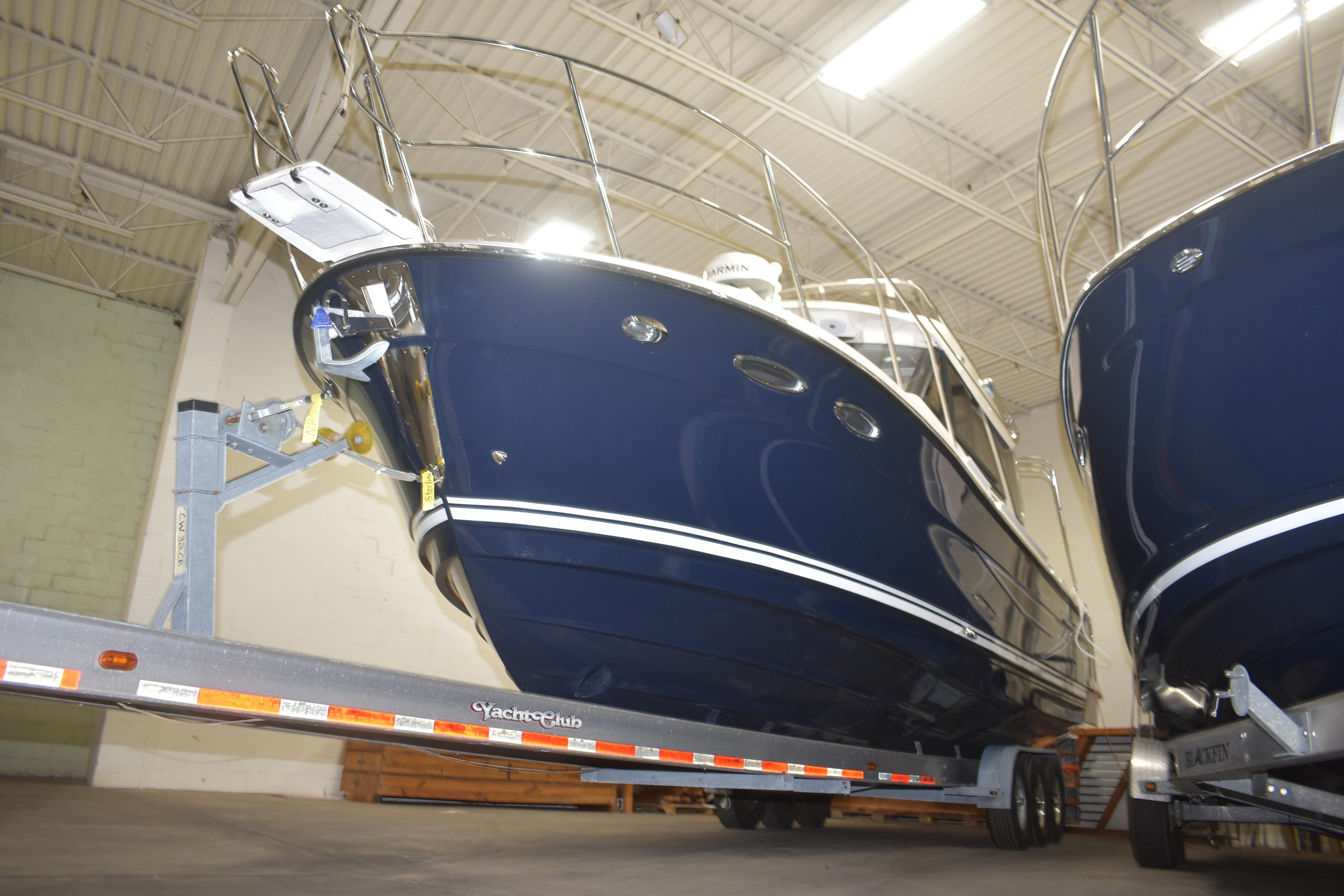 2026 Cutwater C-32 CB boat on trailer in indoor storage facility.