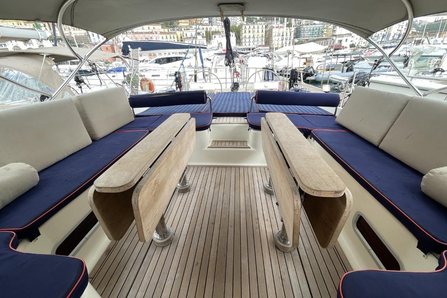 Luxurious 2007 Franchini 63 S yacht interior with blue seating and wooden flooring.