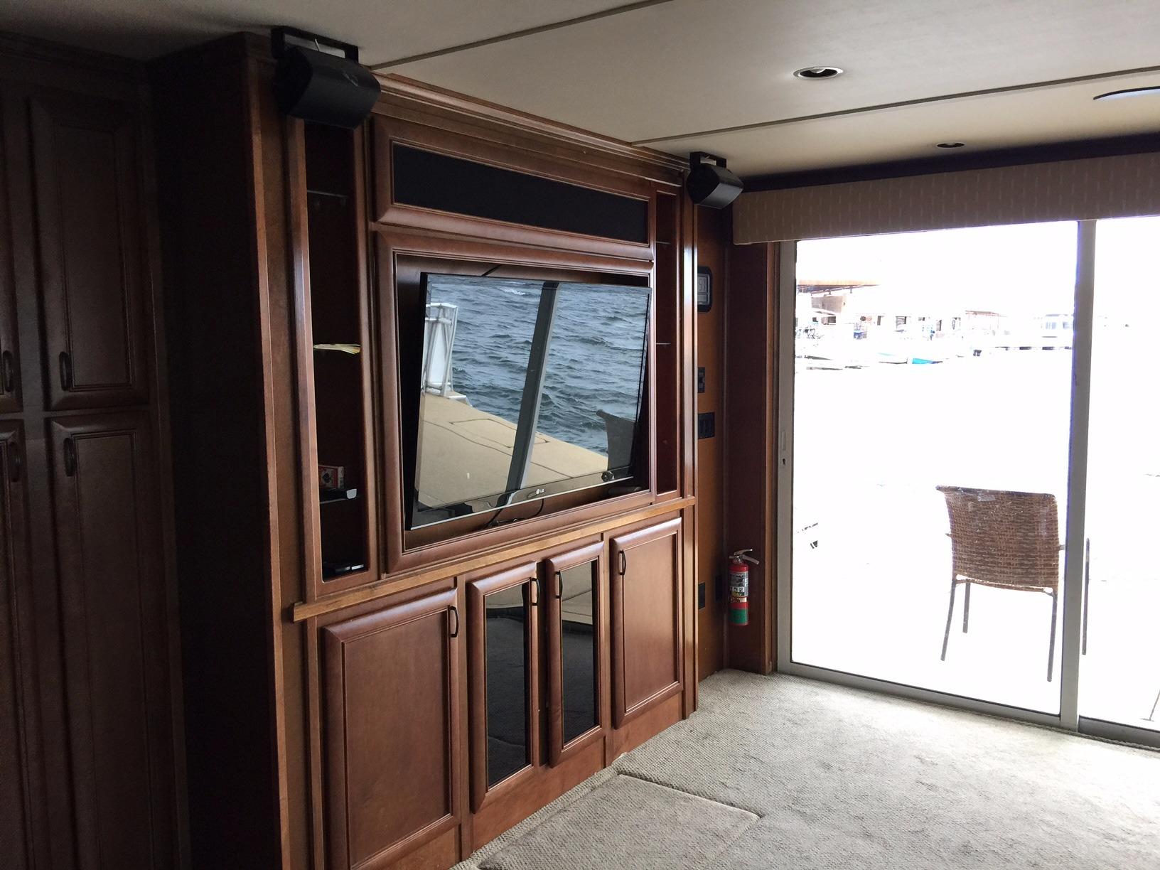 Luxurious interior of 2012 Bravada Ho'okipa Trip 13 houseboat with wood cabinetry and large window.