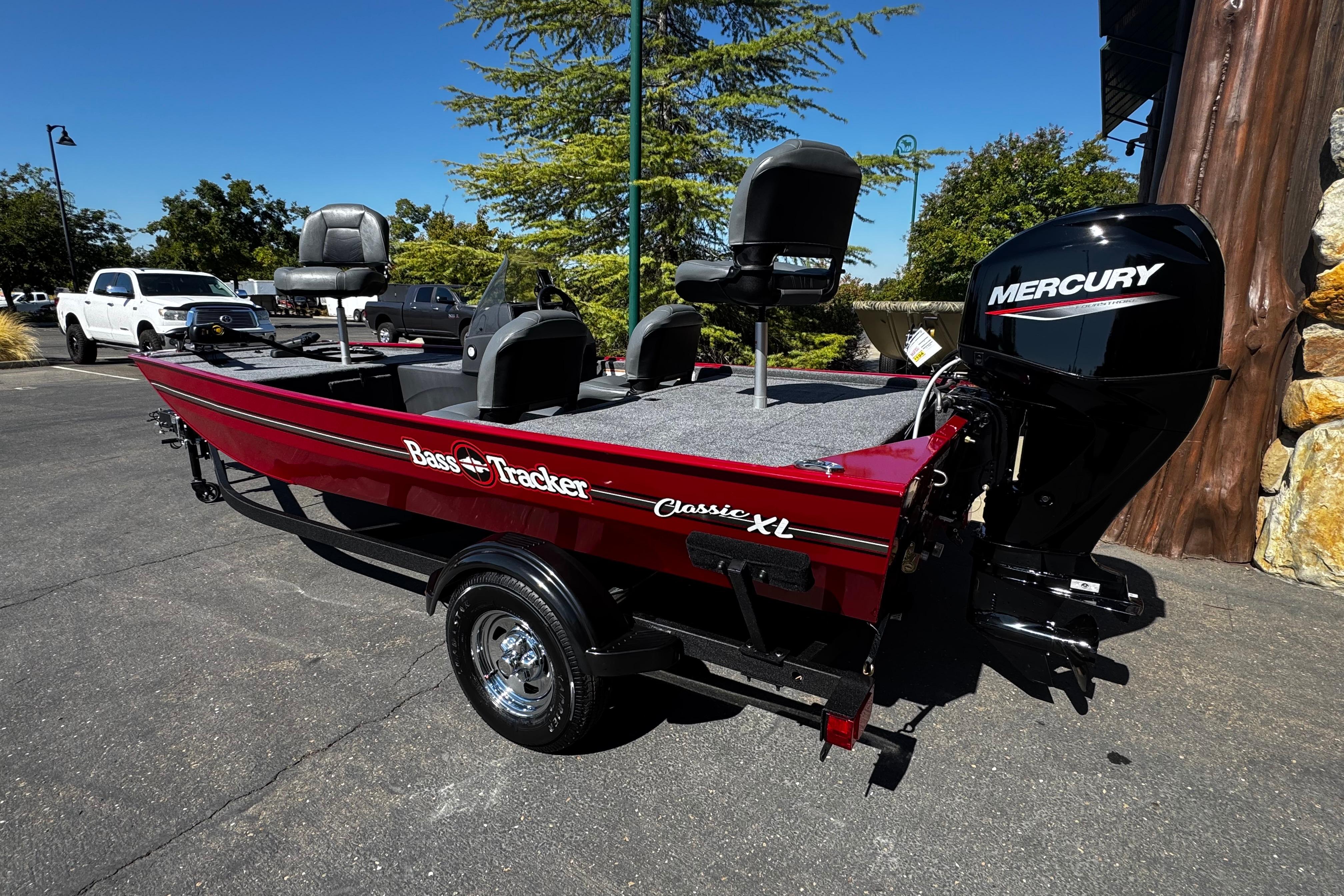2026 Tracker Bass Tracker Classic XL boat with Mercury engine, parked outdoors.