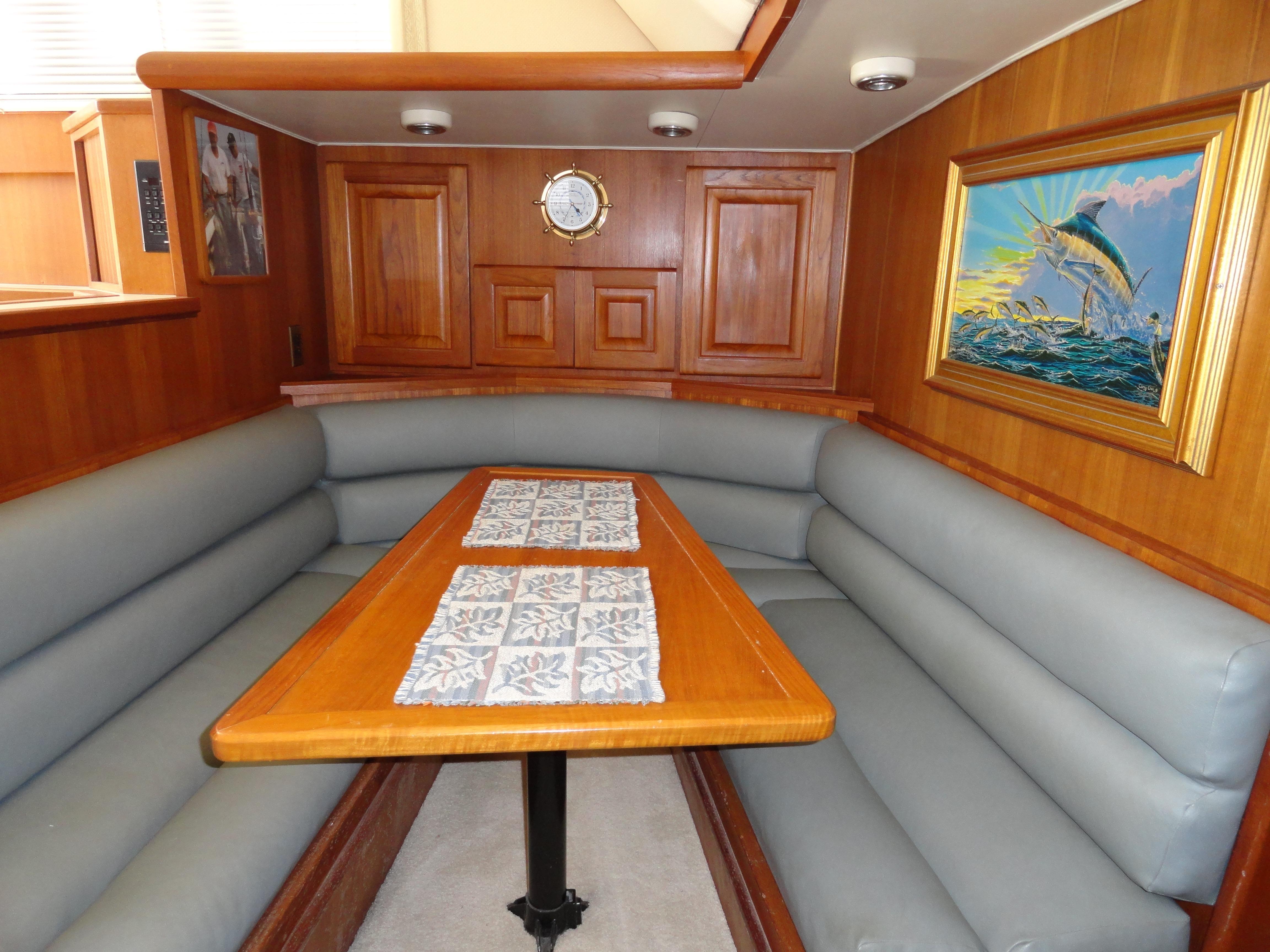 Interior of 1989 Viking 41 Sportfish Convertible with wooden table and artwork.