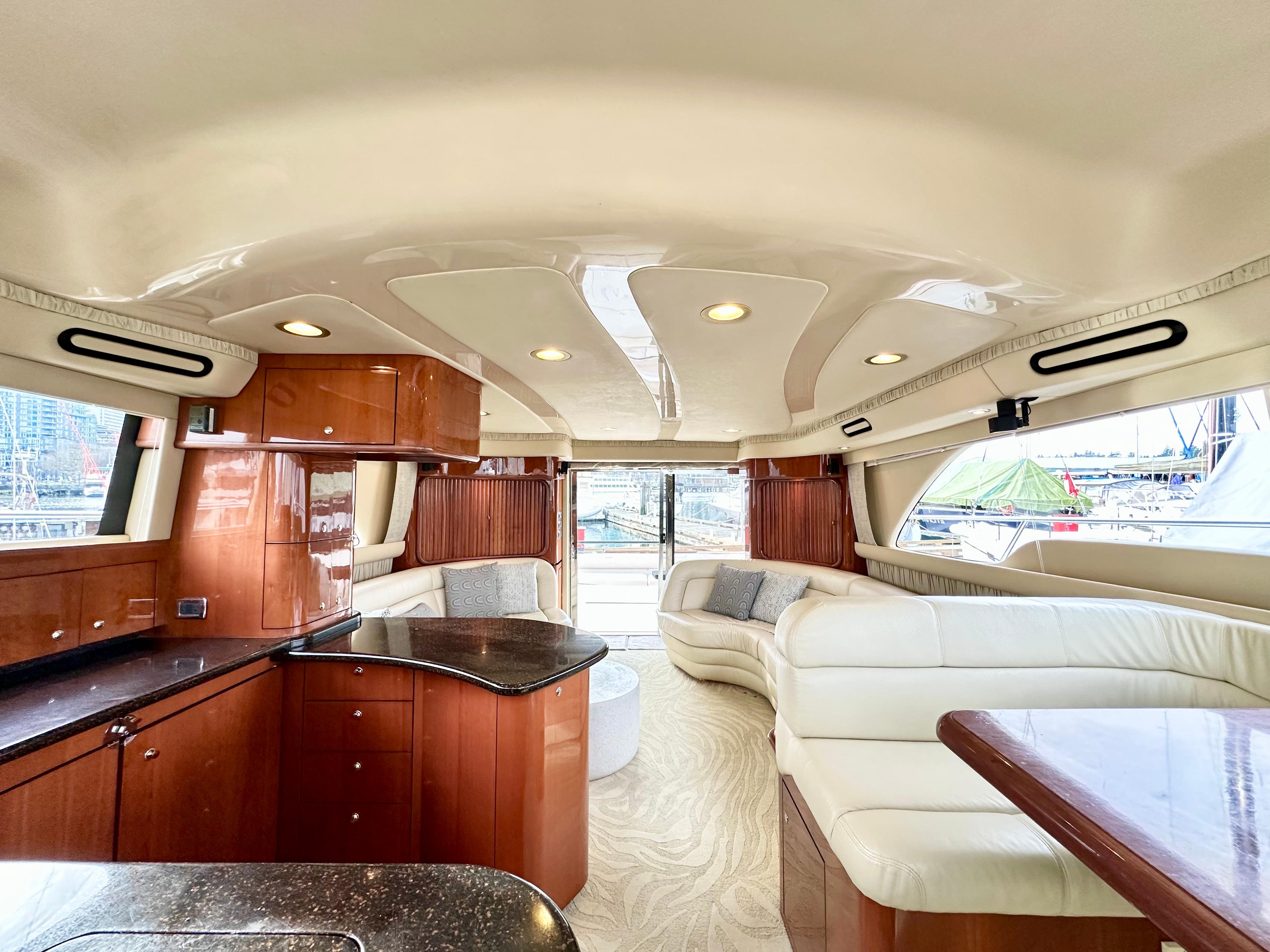 Luxurious interior of 2002 Sea Ray 560 Sedan Bridge yacht with elegant wood and leather finishes.