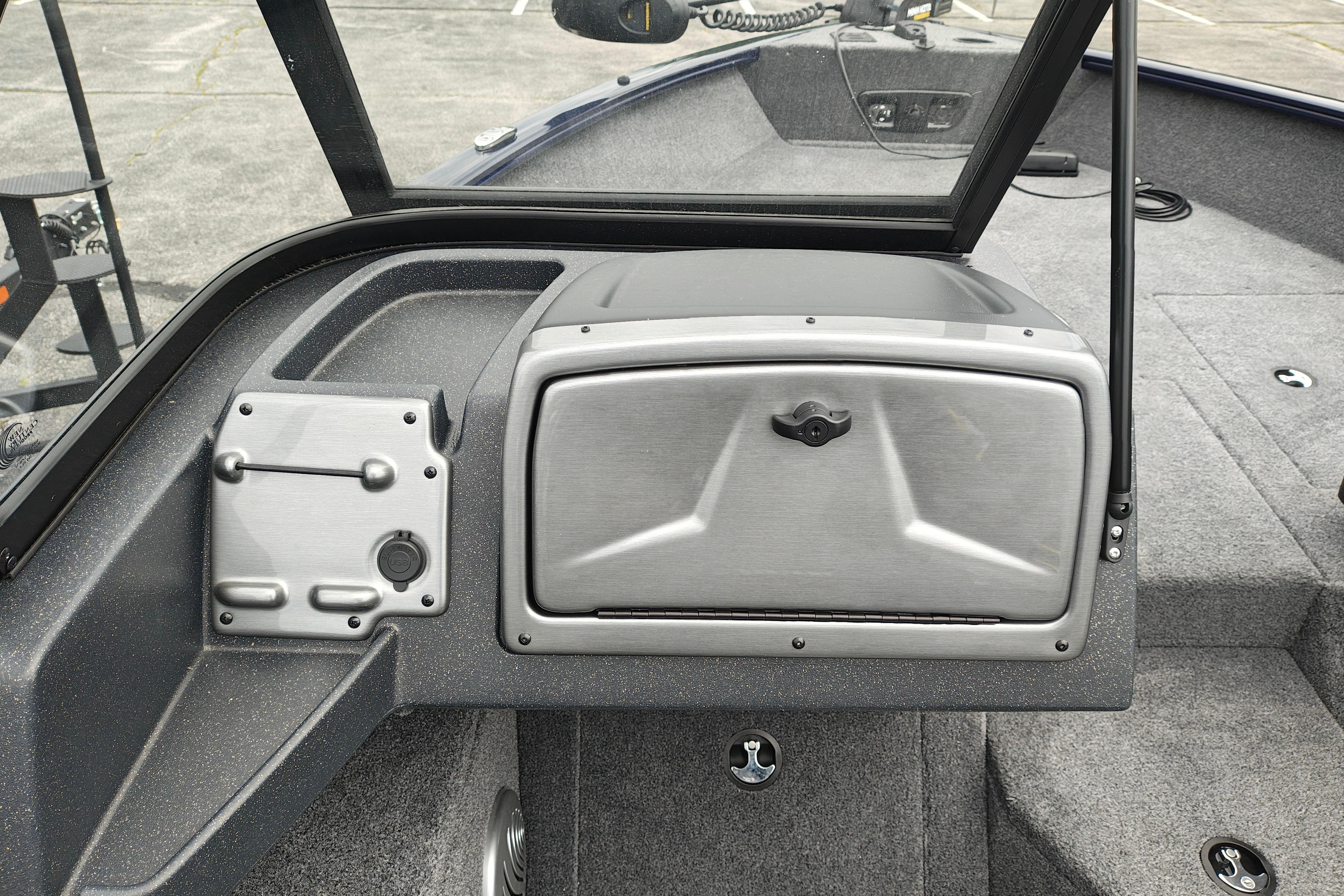 2026 Tracker Pro Guide V-175 WT boat interior with storage compartment and control panel.