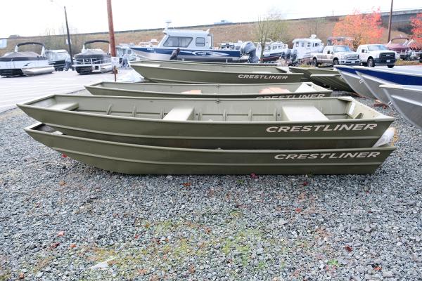 2024 Crestliner 1436L CR Jon boats displayed on gravel lot.