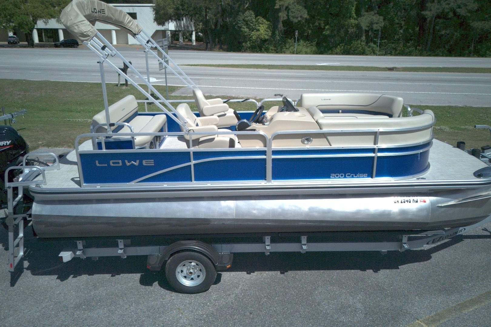 2024 Lowe Ultra 200 Cruise pontoon boat on trailer, blue and beige design.