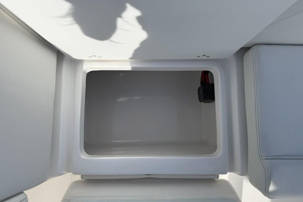 Open storage compartment on 2026 Tidewater 232 LXF boat interior.
