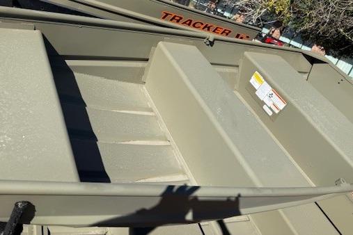 2026 Tracker Grizzly 10 Jon boat interior with seating and storage compartments.