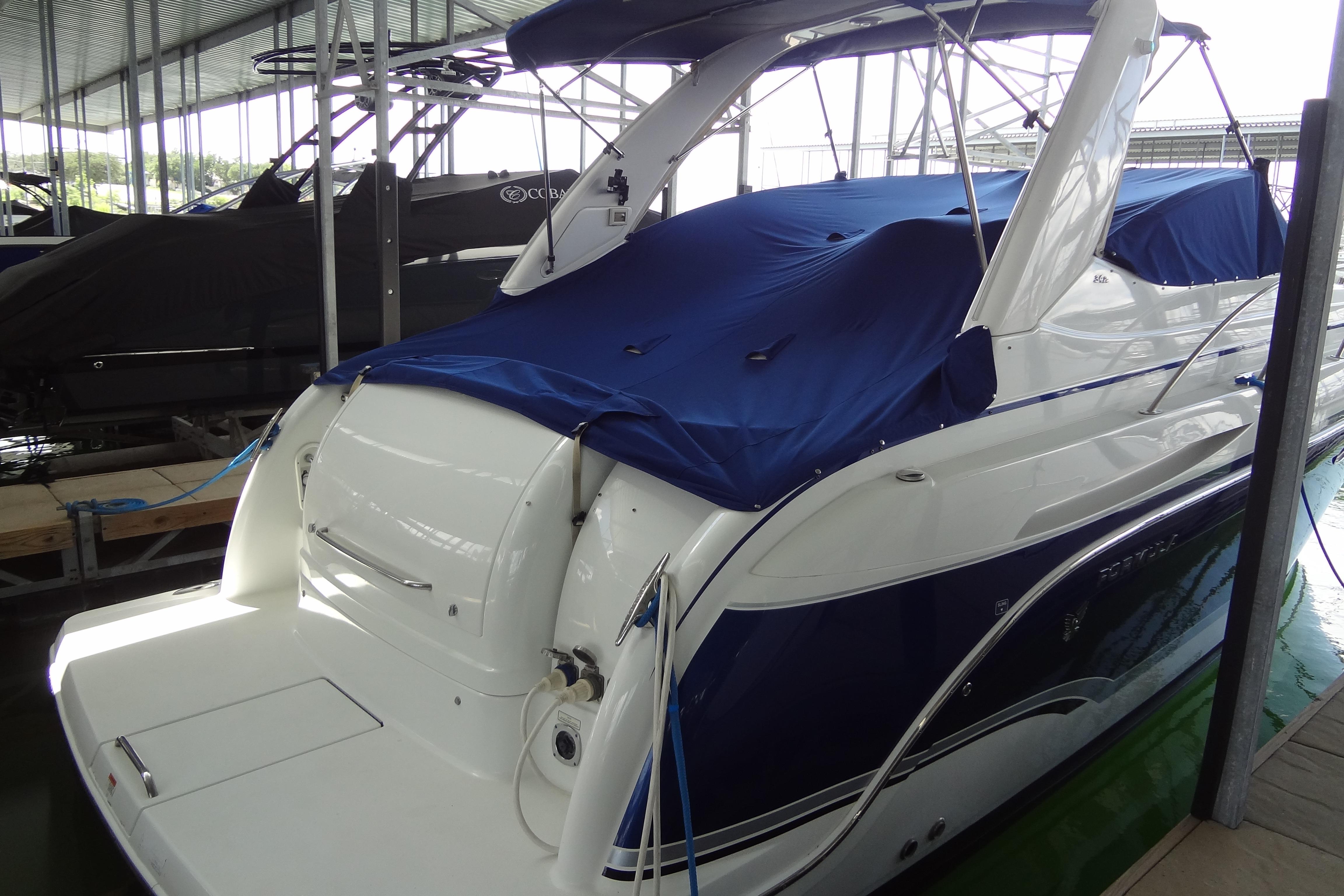 2007 Formula 34 Performance Cruiser with blue cover docked in a marina.