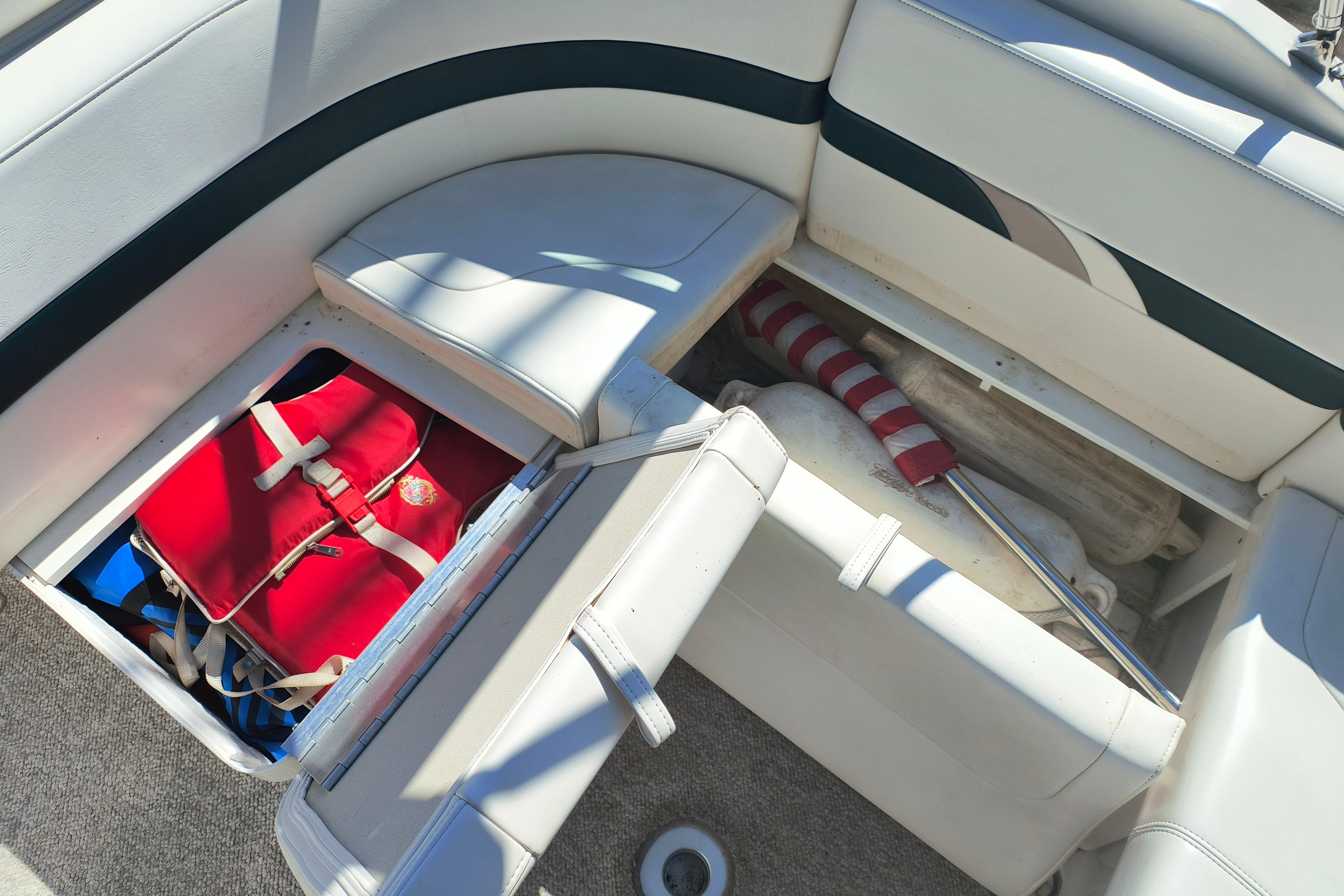 2003 Formula 260 Sun Sport boat interior with storage compartments and safety equipment.