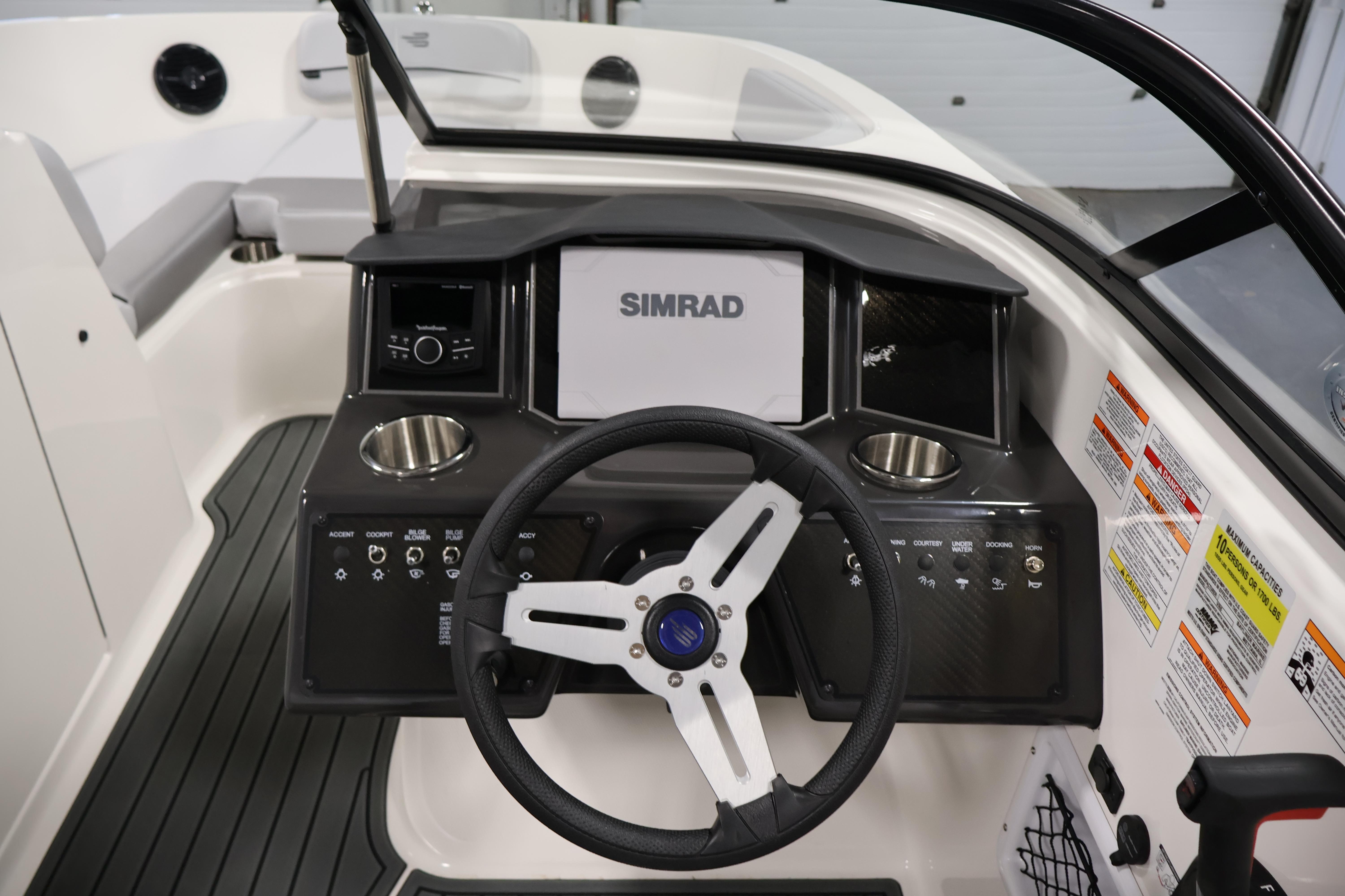 2026 Bayliner VR6 Bowrider I/O dashboard with steering wheel and Simrad display.