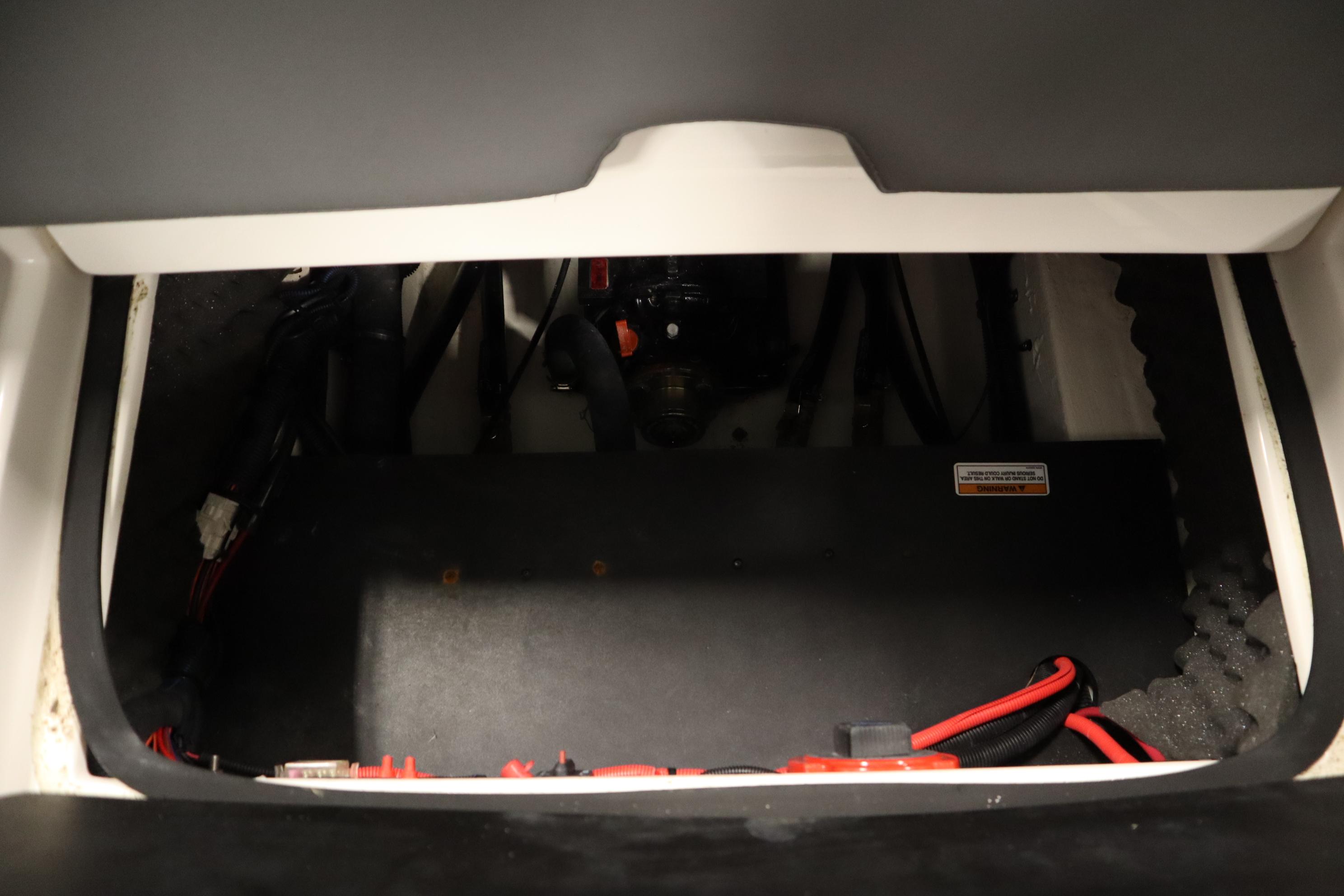 2023 Heyday WT Surf boat interior compartment with wiring and components.