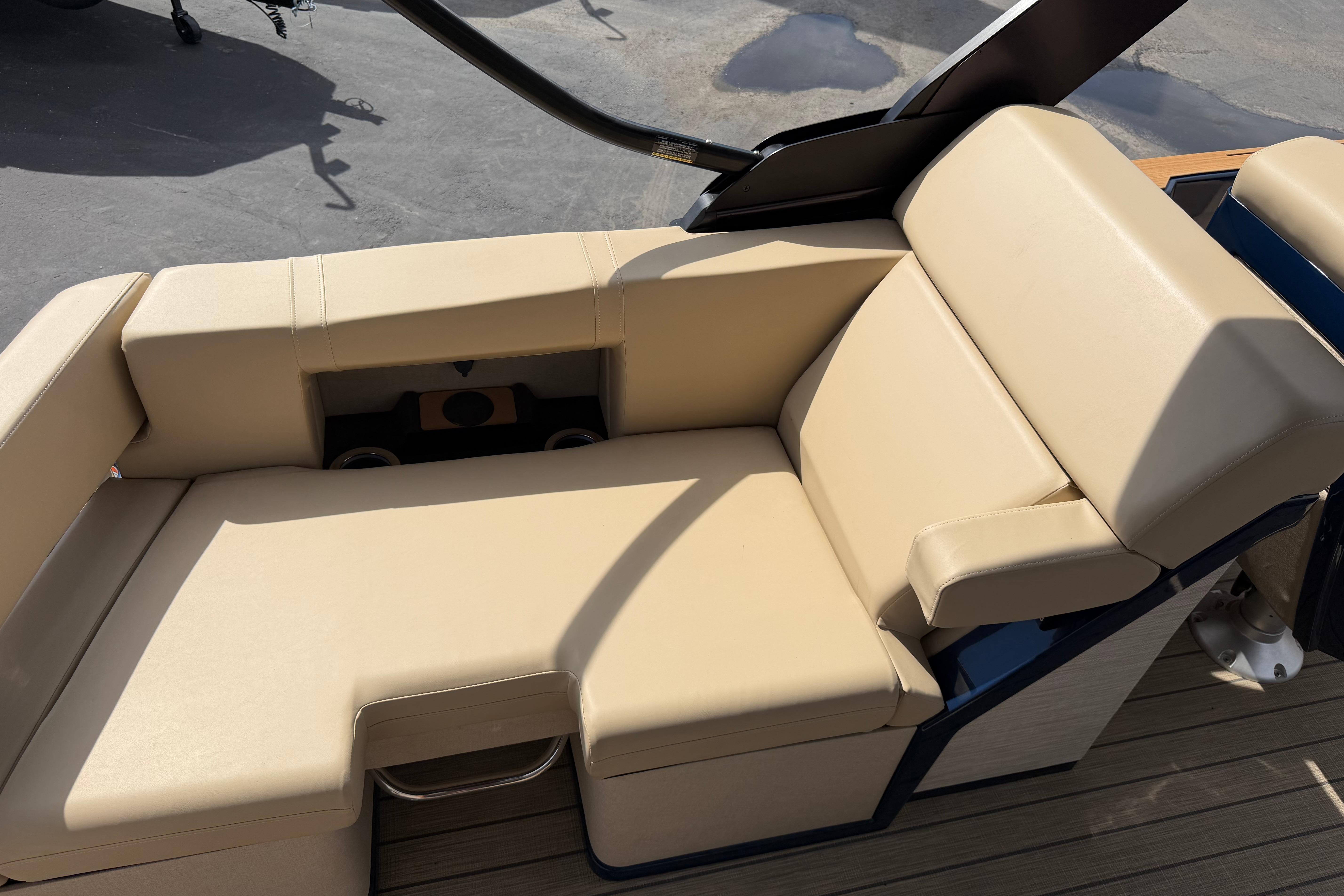 Luxurious beige seating on 2025 Balise HORIZON26C boat, featuring cup holders and sleek design.