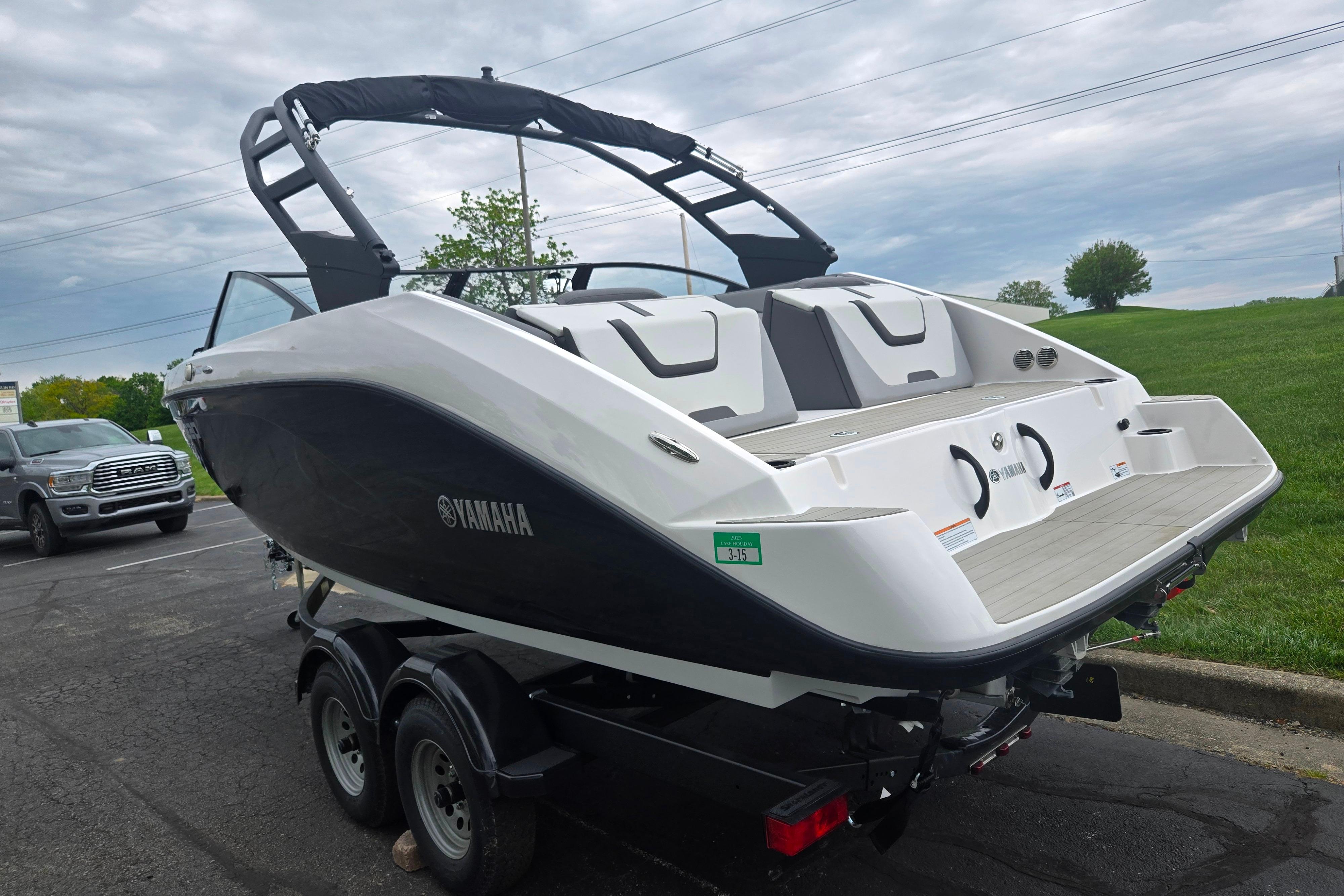 2024 Yamaha Boats AR220 on trailer, sleek design, parked outdoors.