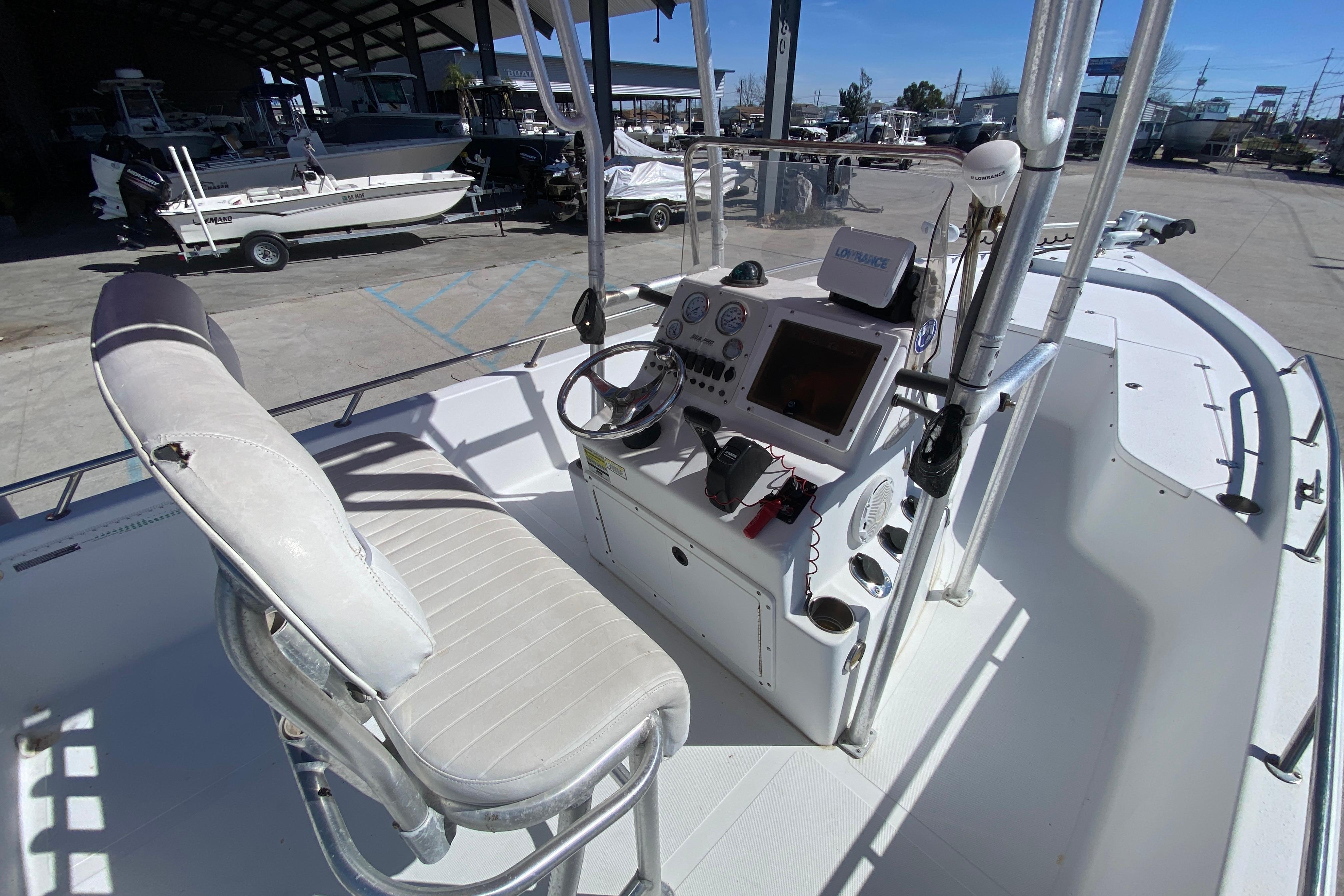 2005 Sea Pro SV2400CC Bay Boat cockpit with steering wheel and navigation equipment.