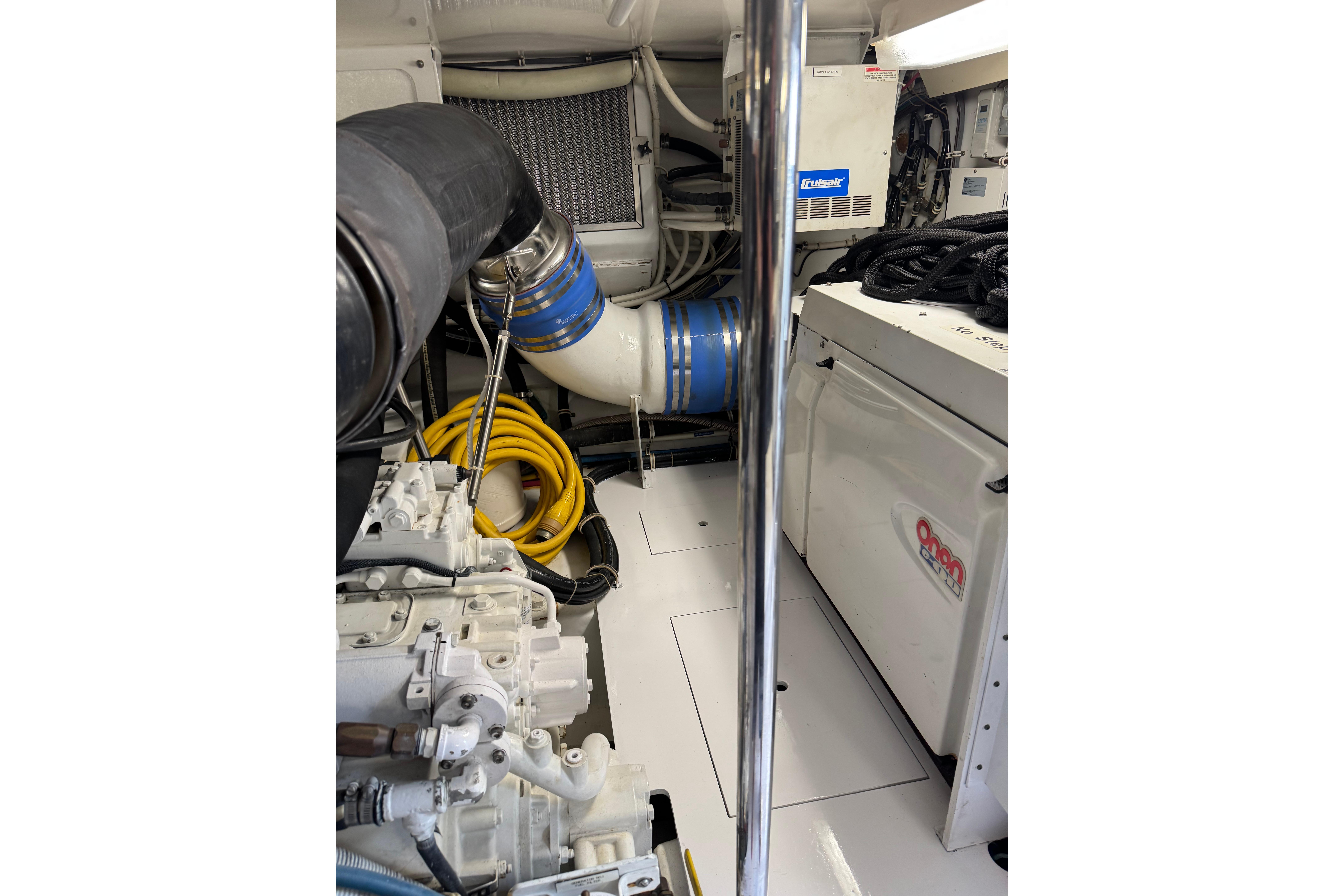Engine room of 2004 Hatteras 60 Convertible yacht with visible machinery and equipment.