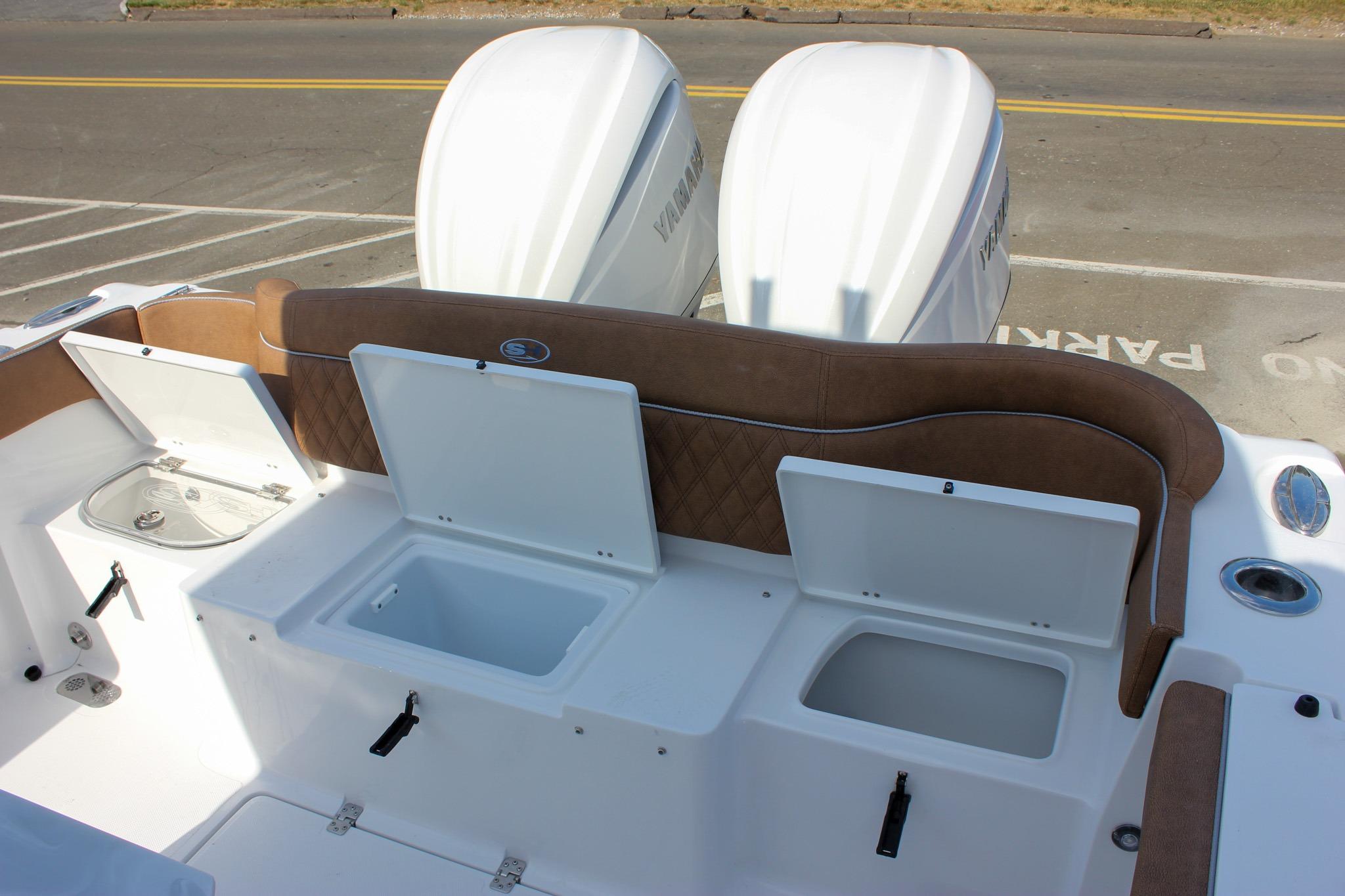 2027 Sea Hunt Ultra 275 SE boat with open storage compartments and twin engines.