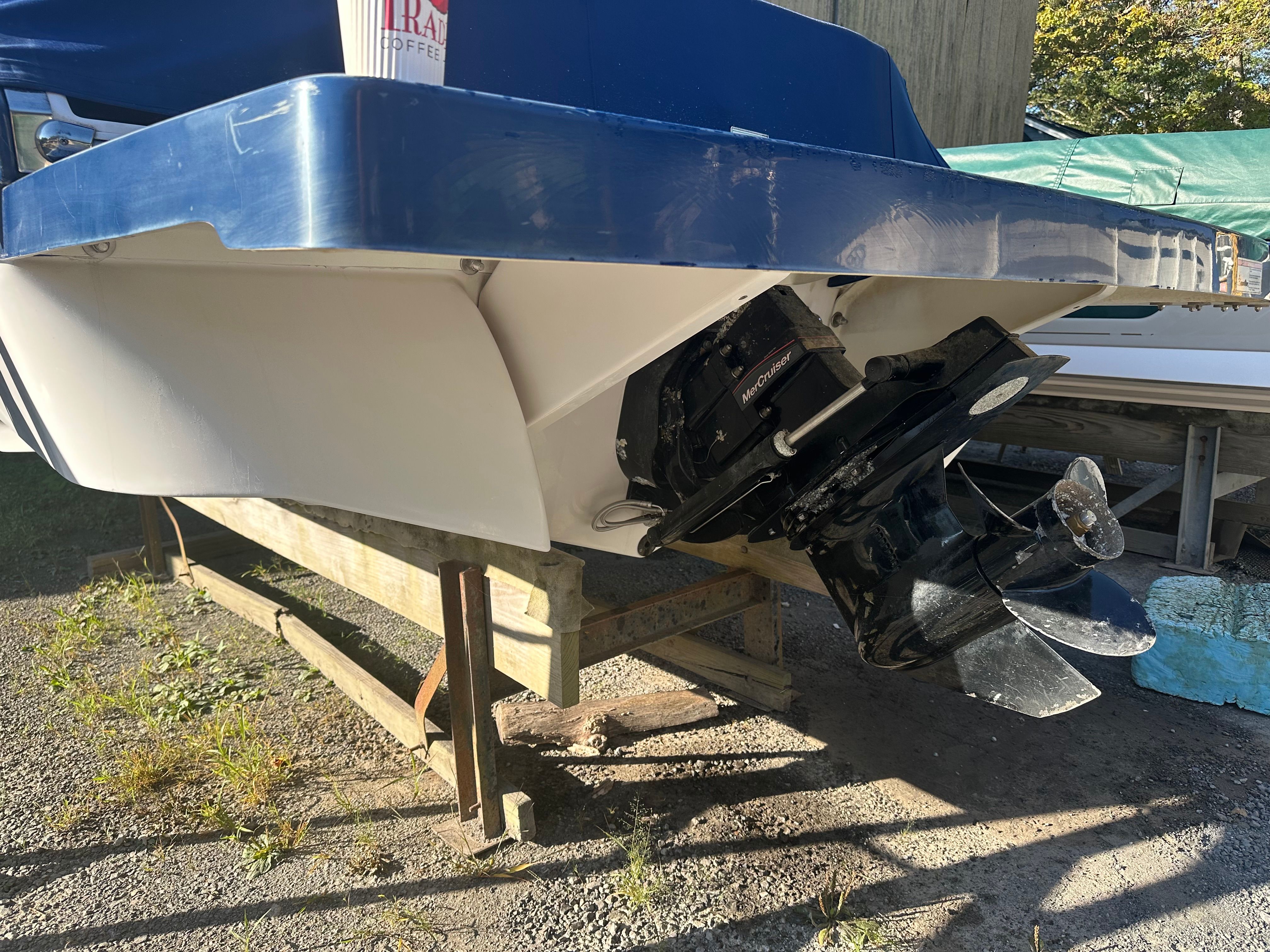 Rear view of a 2012 Four Winns H210 boat with outboard motor.
