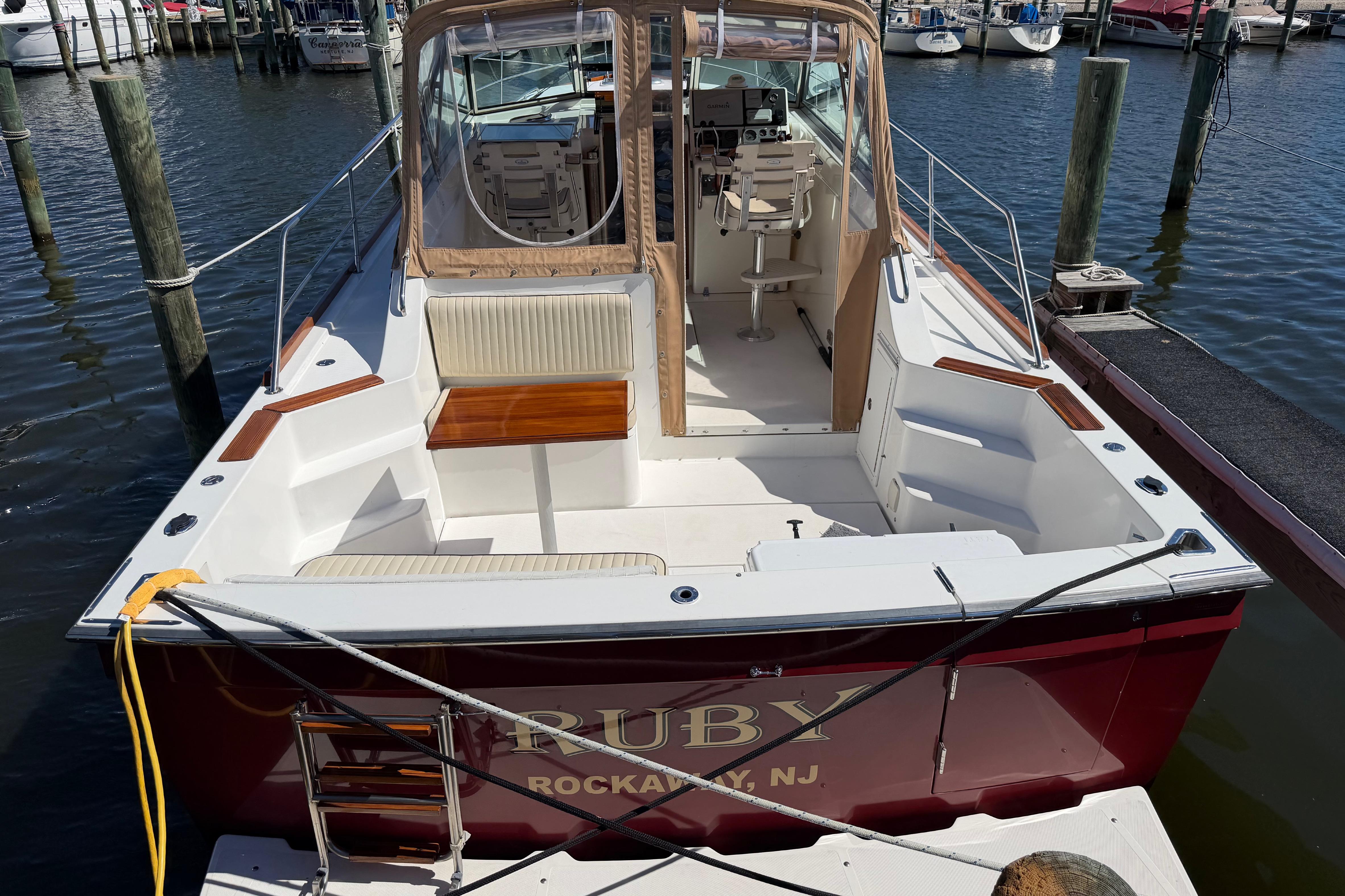 2000 Sabreline 36 Express boat docked, featuring spacious seating and elegant design.