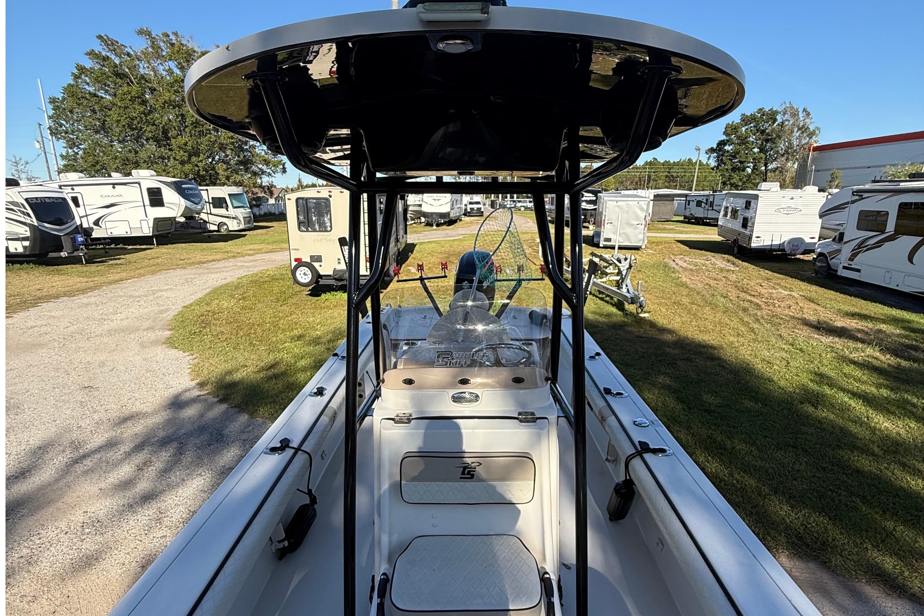 2021 Carolina Skiff 26 Ultra Elite boat in RV park, showcasing interior and T-top.