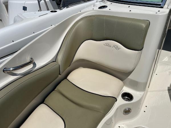 2005 Sea Ray 220 Sundeck boat interior with cushioned seating and cup holder.